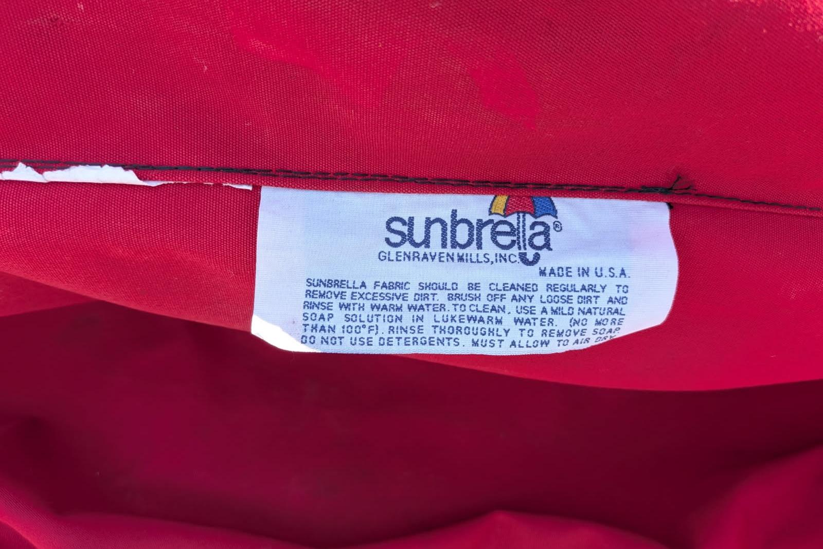 Red Sunbrella fabric label with cleaning instructions, made in the USA. Cobalt 206, 2020.