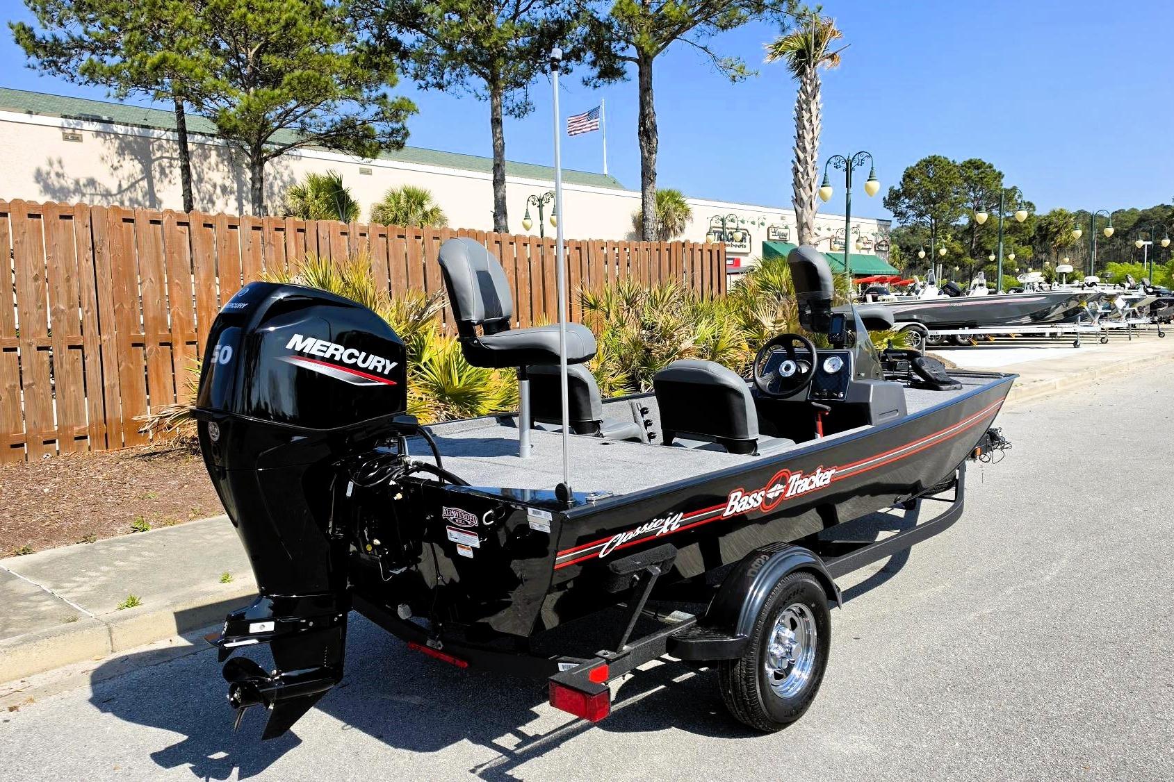 2026 Tracker Bass Tracker Classic XL boat with Mercury engine, parked outdoors.