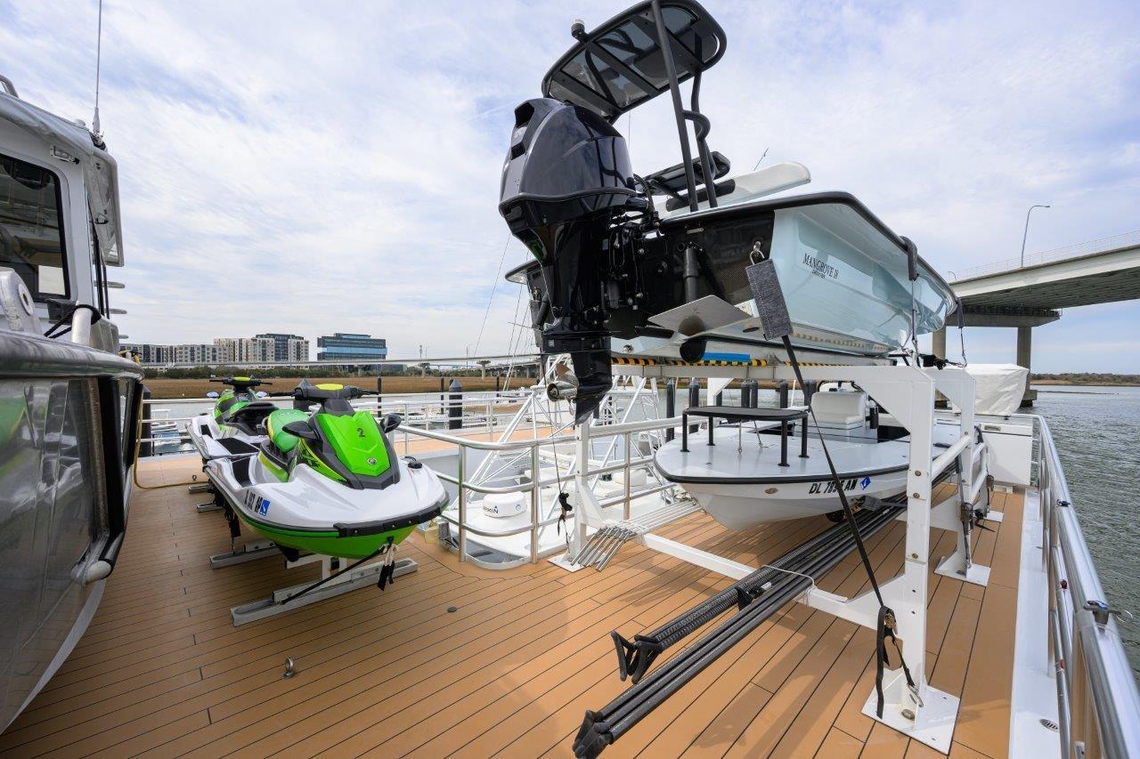 Deck of 2011 C & G Boatworks Explorer with jet skis and small boat.