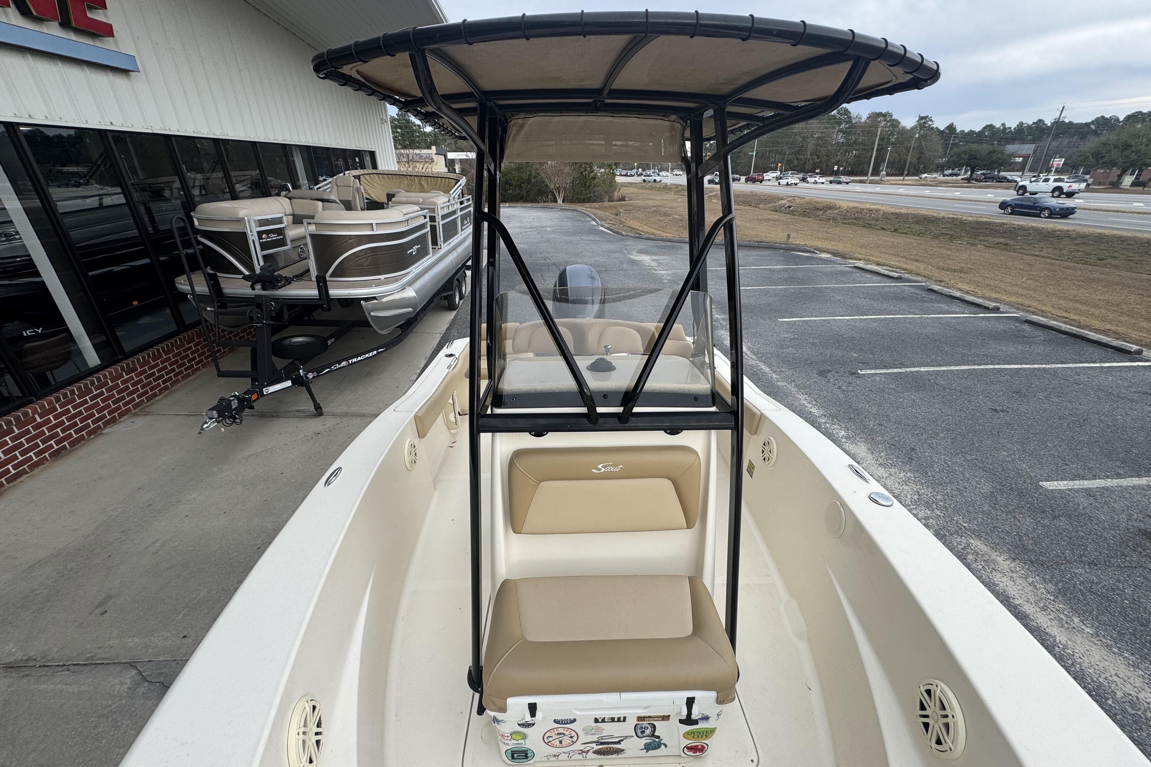 2020 Scout 195 Sportfish boat with T-top, parked near dealership.