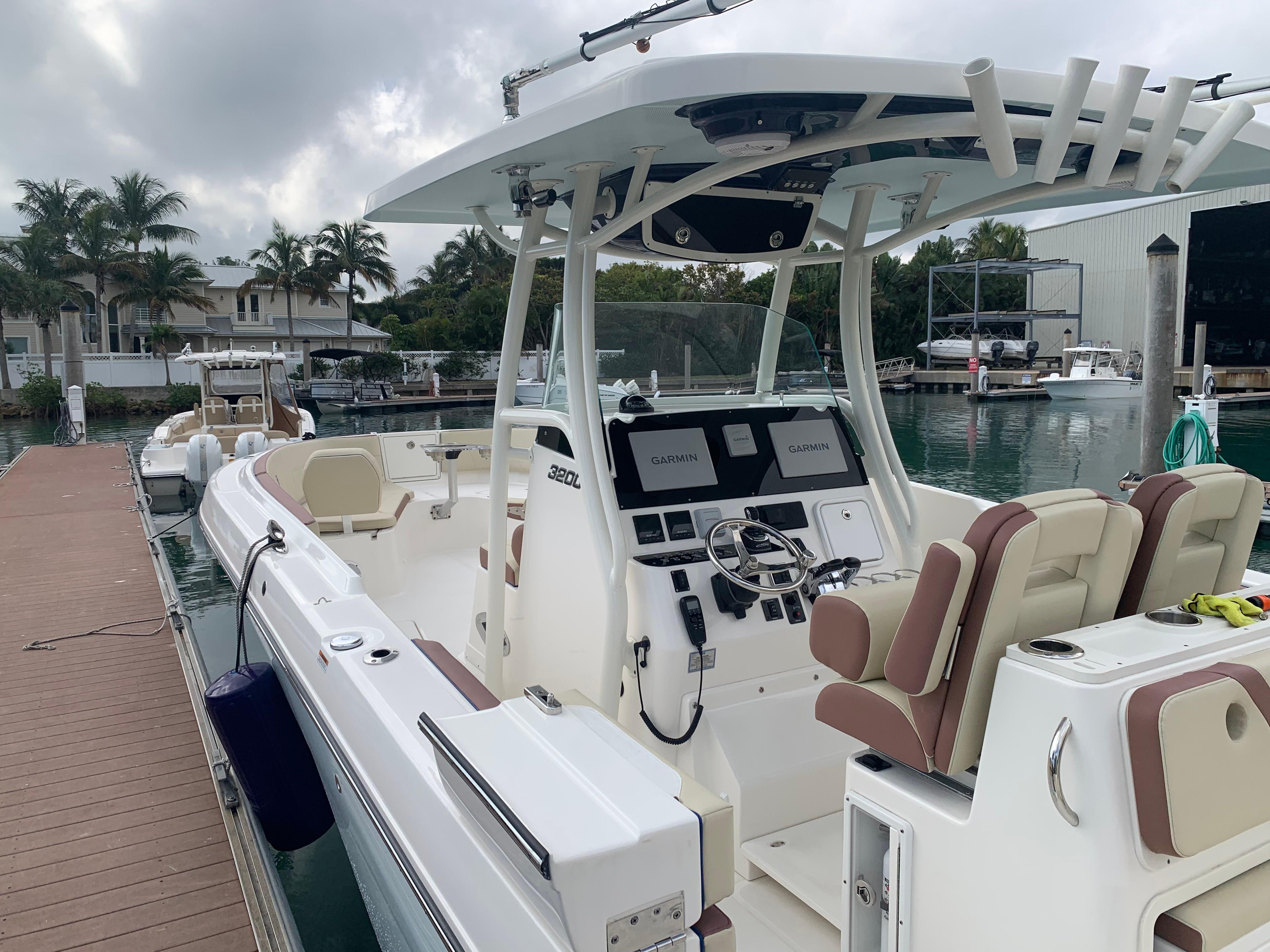 2019 Century 3200 Center Console boat docked at marina, featuring modern helm and seating.