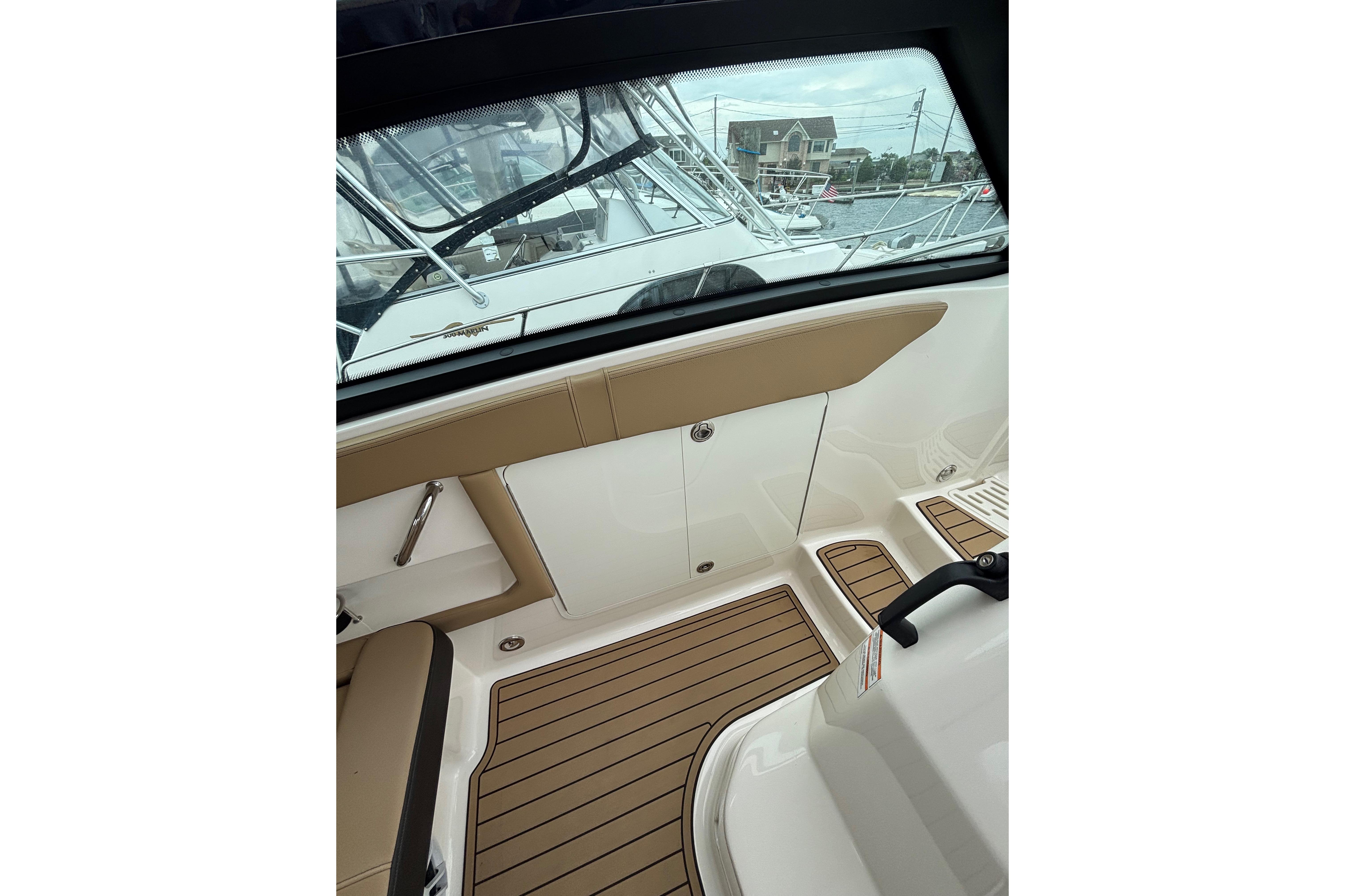 Interior view of 2021 Sea Ray Sundancer 320 Outboard with teak flooring and seating.