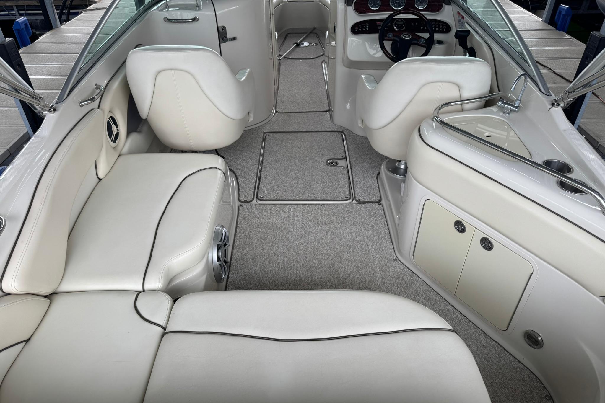 2008 Sea Ray 240 Sundeck interior with white seating and modern dashboard.