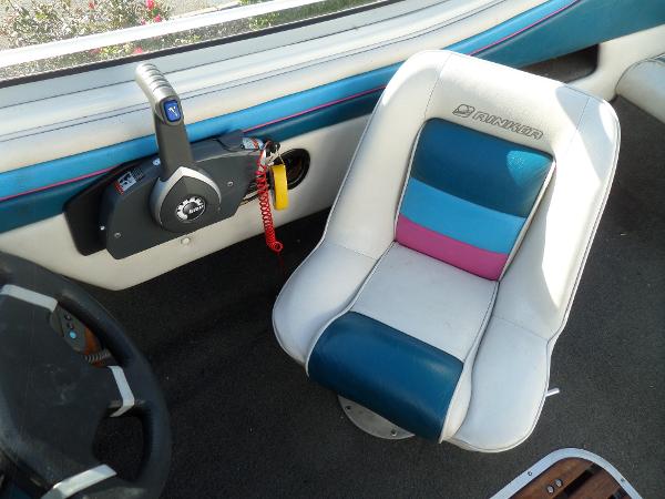 Interior of 1992 Rinker Captiva 170 OB boat with colorful seat and control panel.