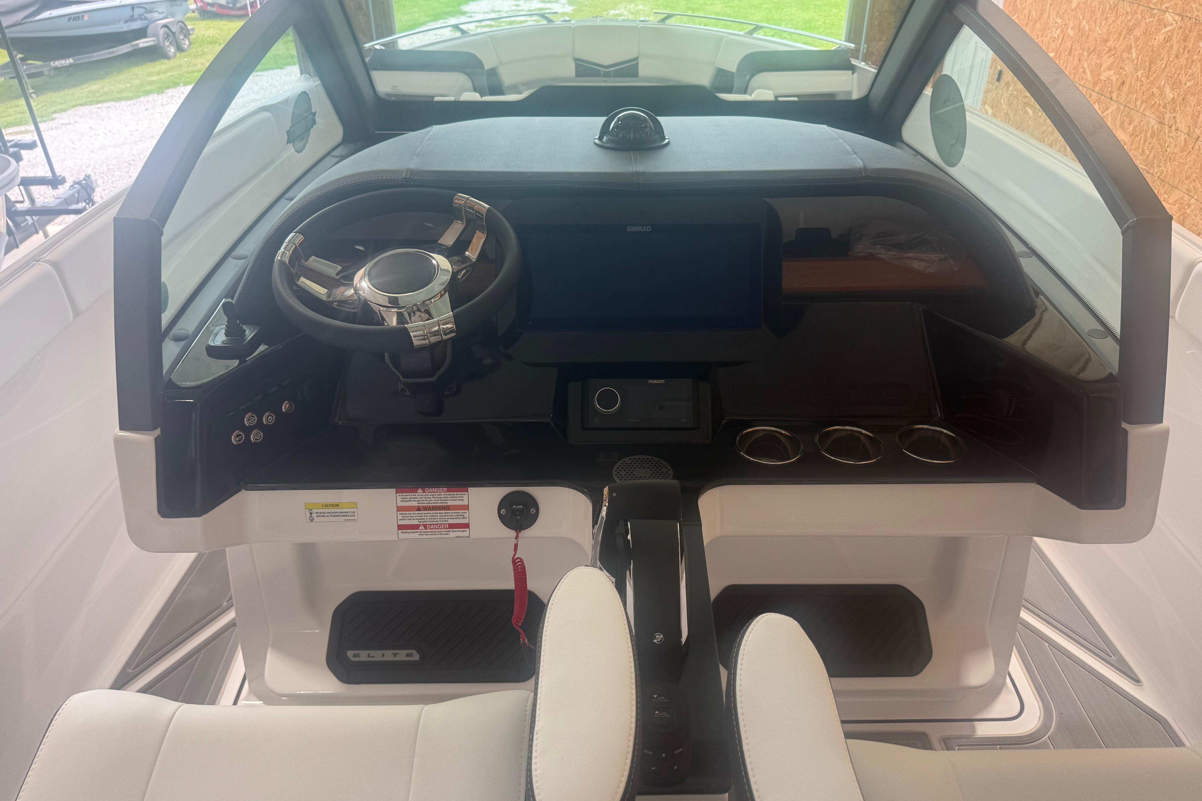 Cockpit of 2027 Monterey Elite 27 SD boat with modern steering and dashboard controls.