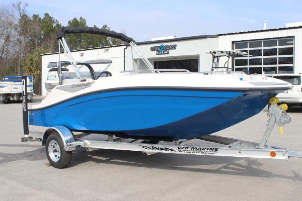 2025 Starcraft SV 16 OB boat in blue on a trailer outside a marine dealership.