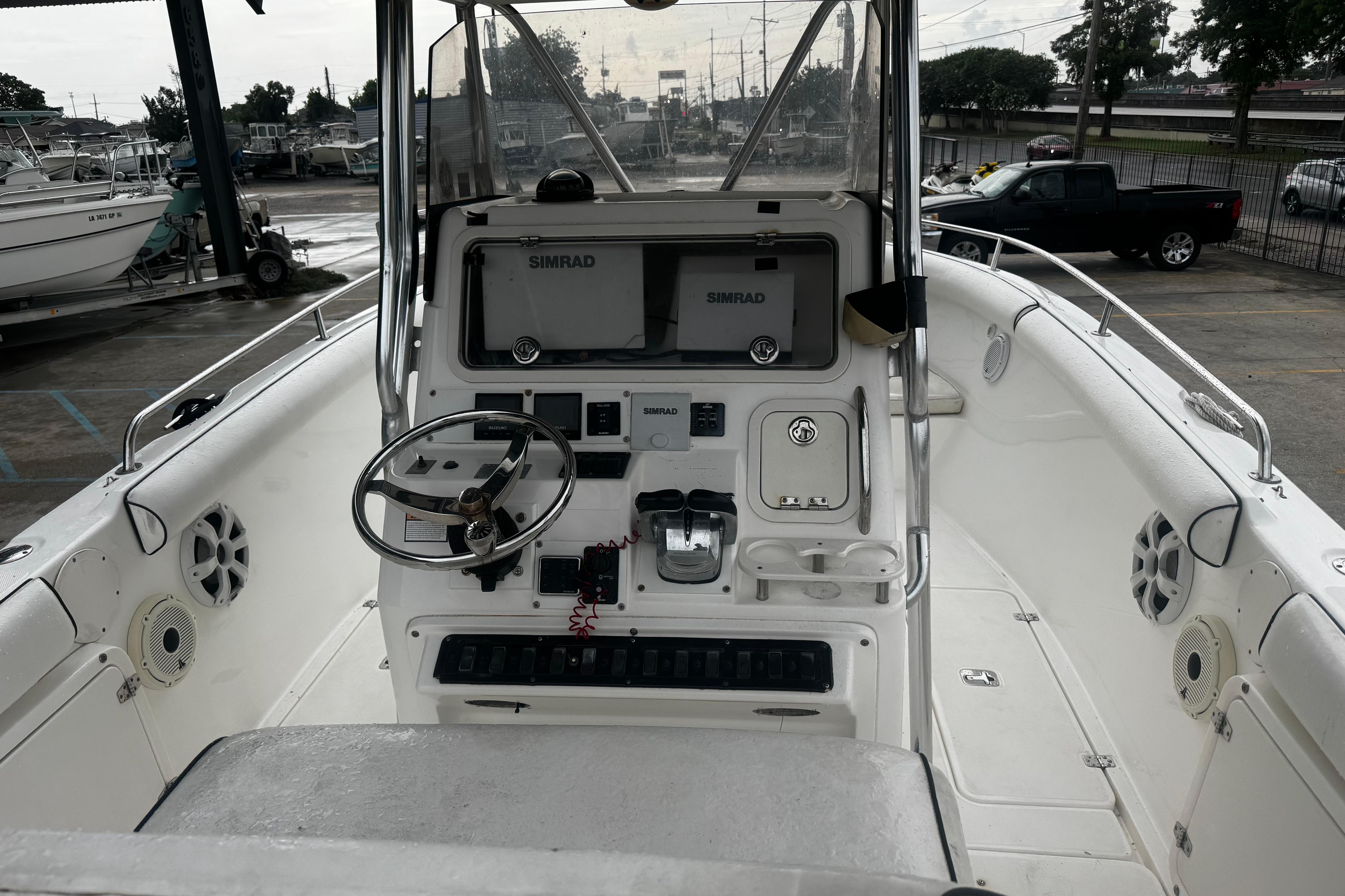 2004 Century 2900 Center Console boat interior with steering wheel and Simrad navigation system.
