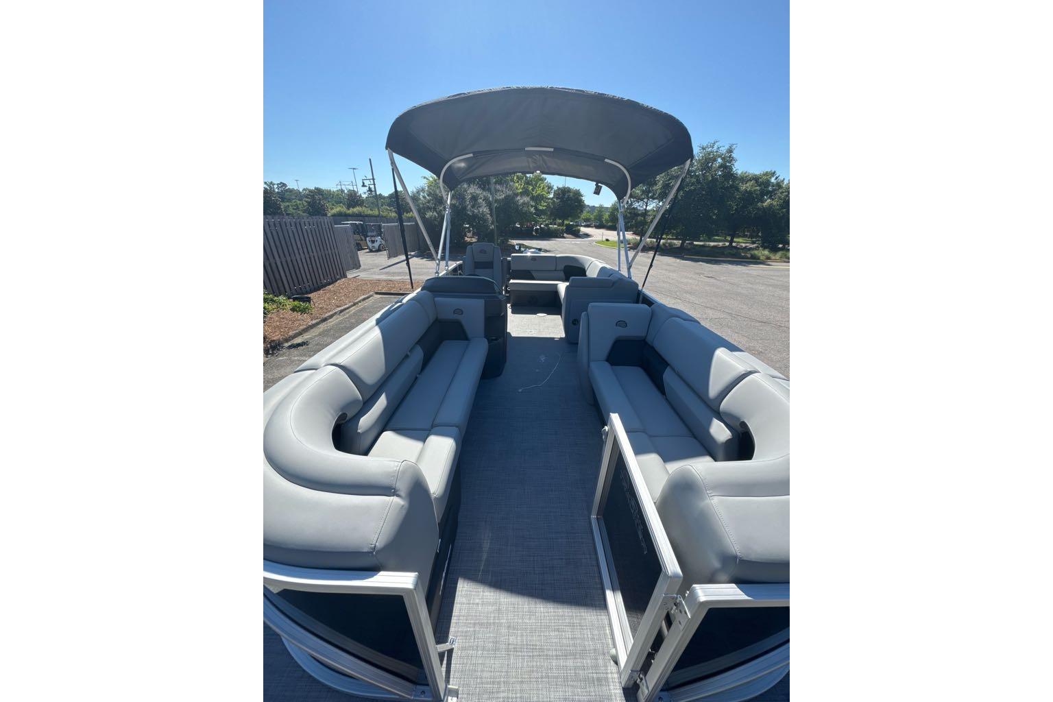 2026 Sun Tracker Party Barge 20 DLX pontoon boat with spacious seating and canopy.