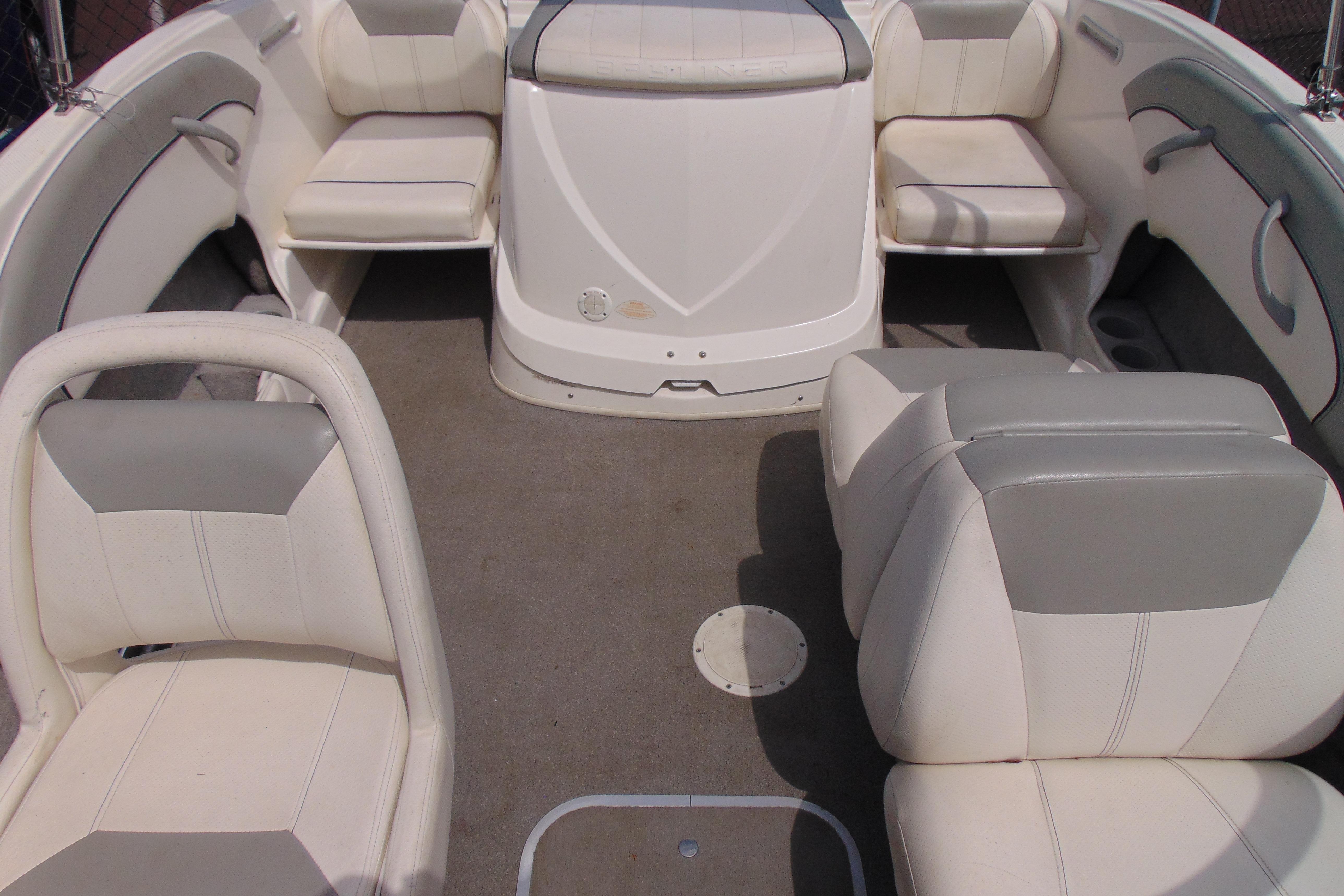 Interior of a 2012 Bayliner 185 Bowrider boat with white and gray seating.