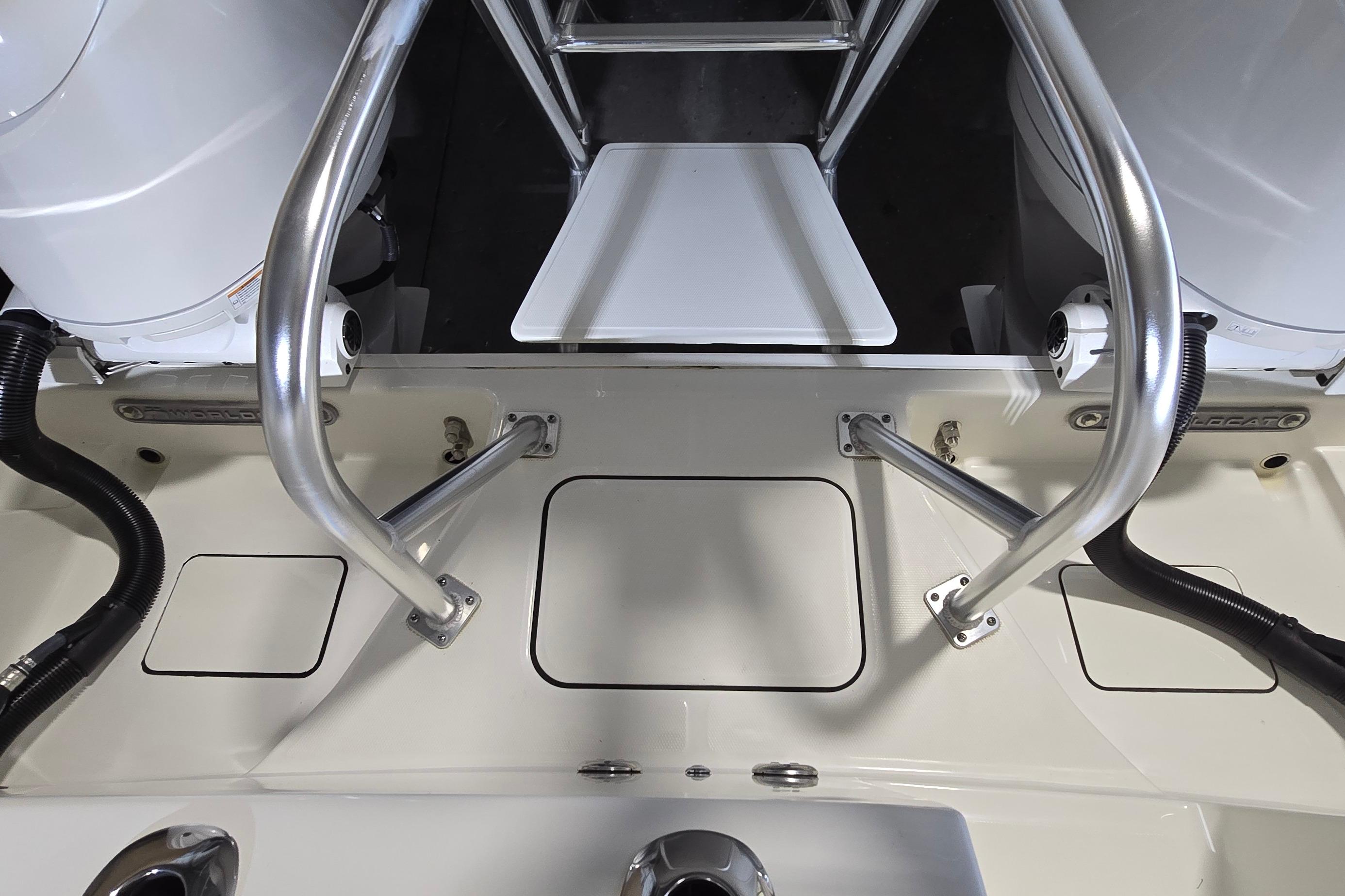 2024 WorldCat 280 CC-X boat deck with stainless steel railings and engine components.