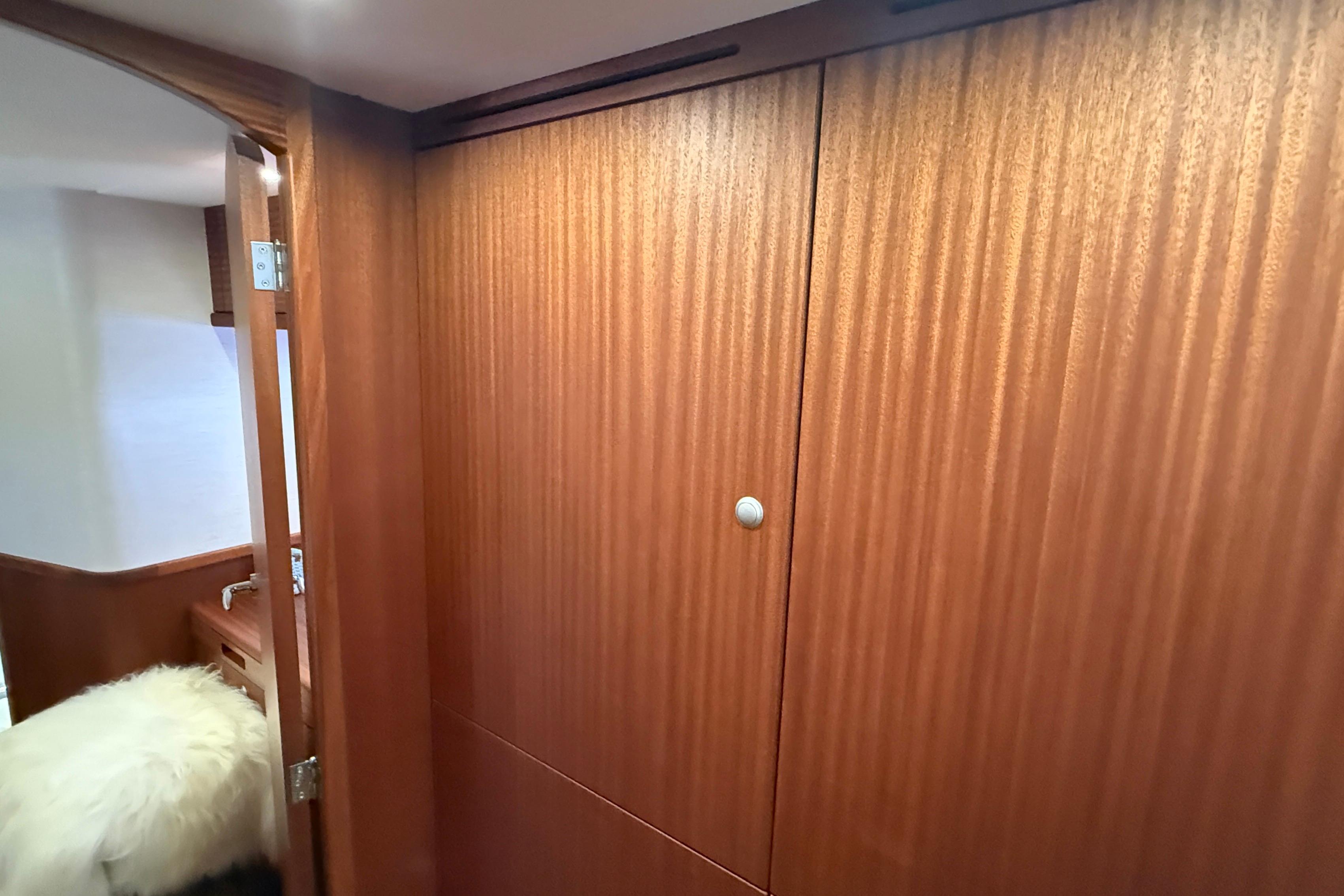Interior of 2021 Elling E6 yacht with wooden paneling and cozy furnishings.