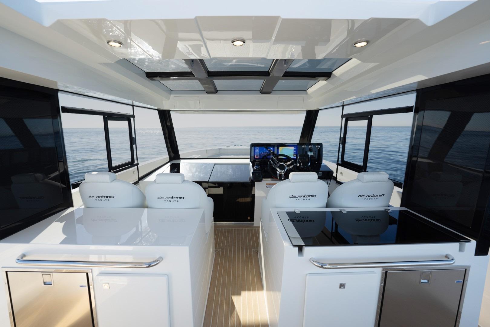 Interior of 2026 De Antonio Yachts 50 Coupe, featuring modern helm and seating.