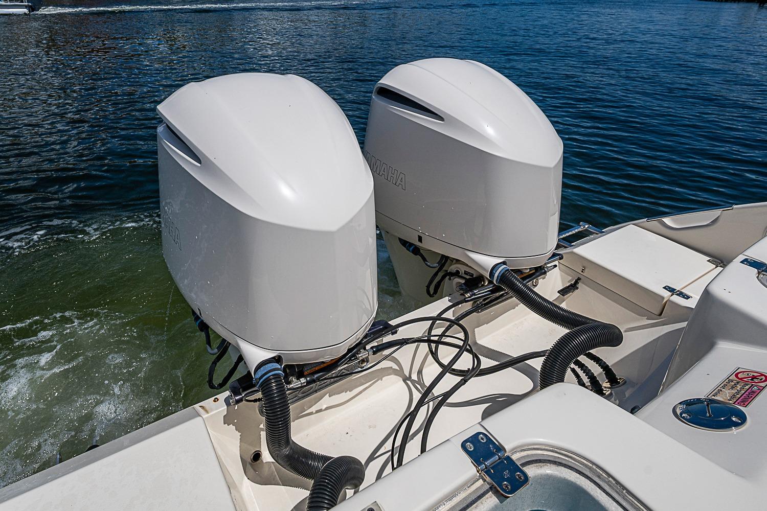2019 Cobia 320 Center Console with twin outboard engines on water.