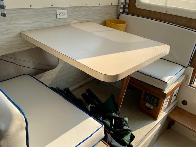 1972 Bertram Express boat interior with dining area and cushioned seating.