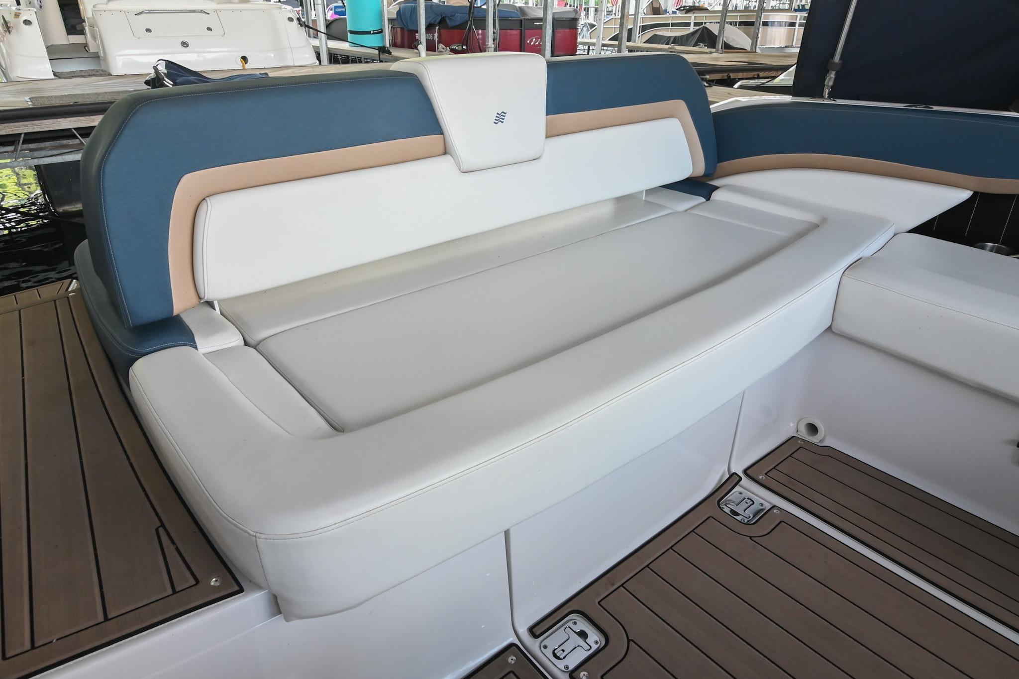 2014 Four Winns H290 boat seating with blue and tan accents, docked in a marina.