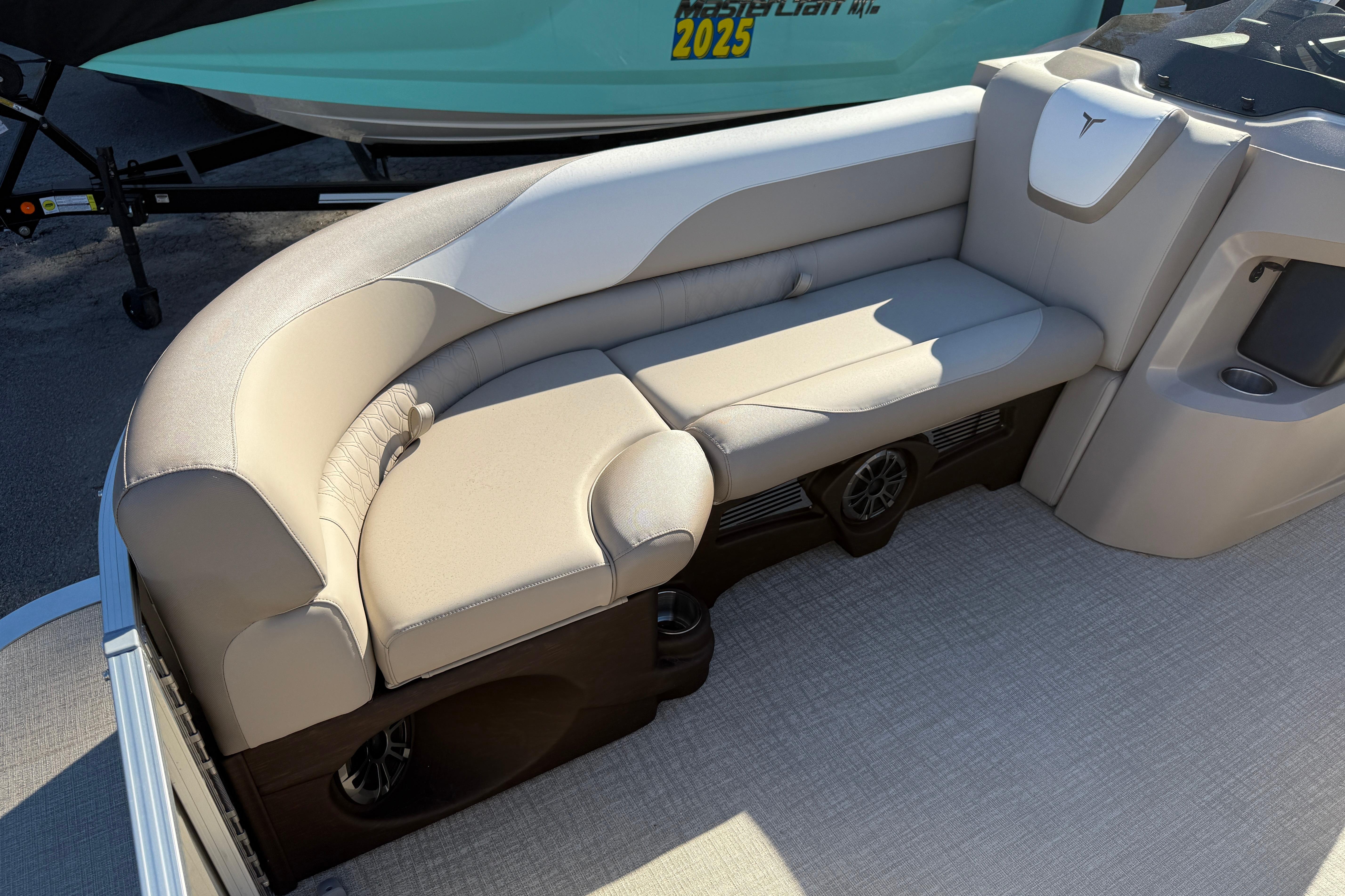2026 Tahoe Pontoon LTZ Versatile Rear Lounger with beige seating and integrated speakers.