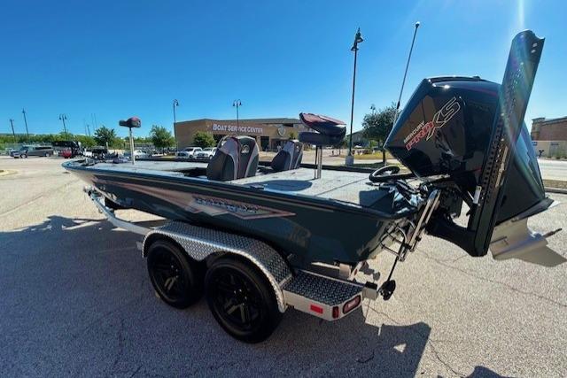 2025 Ranger ALPHA 208 boat on trailer, parked outdoors under clear blue sky.