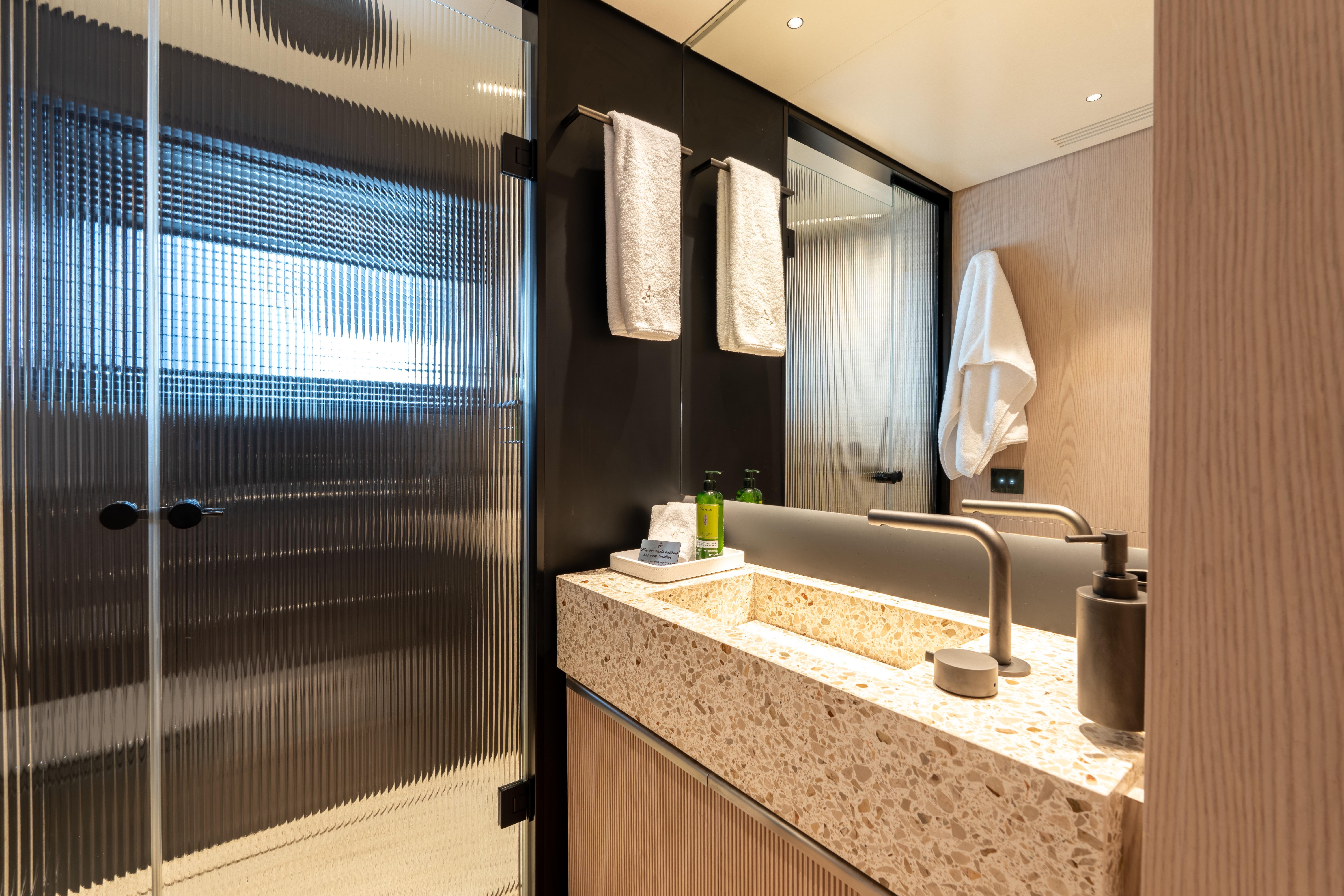 Luxurious bathroom in 2024 Benetti Oasis yacht with modern fixtures and elegant design.