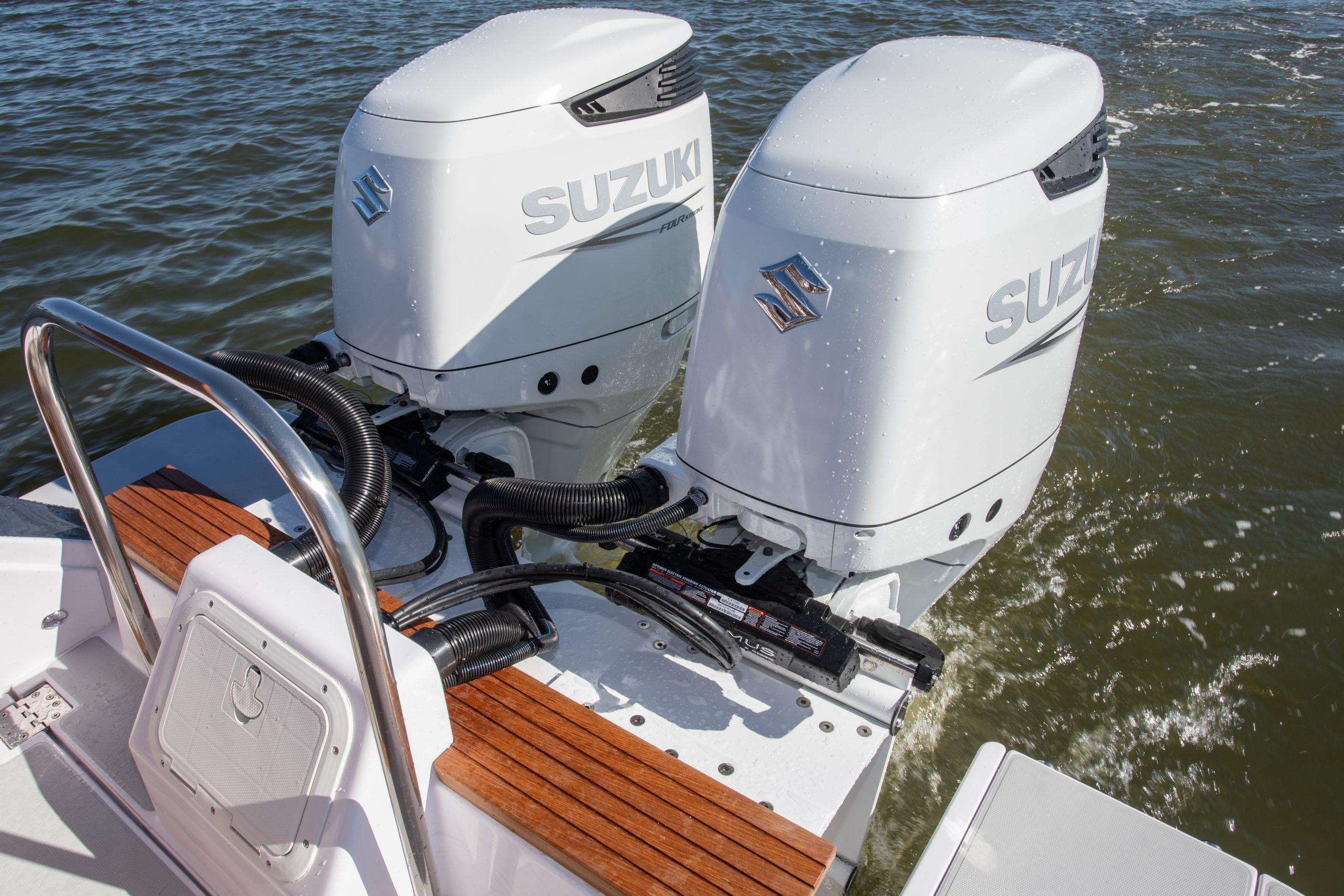 Twin Suzuki outboard motors on 2024 True North 34 boat in water.