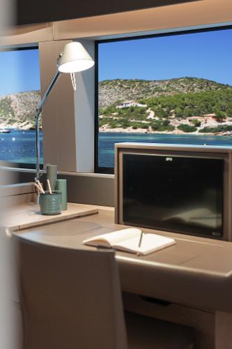 Interior of 2025 Lagoon SIXTY 5 yacht with ocean view through window.