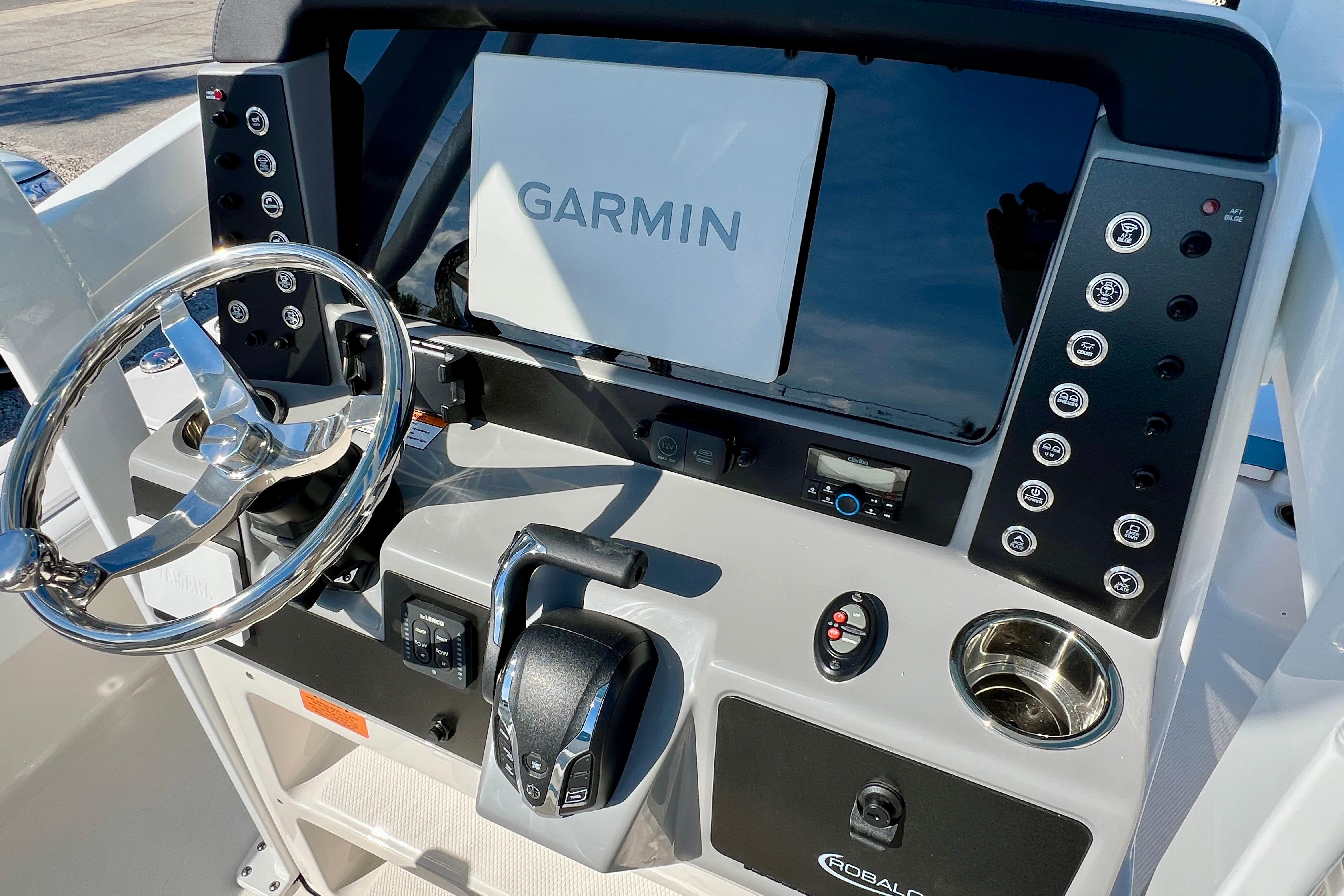 2026 Robalo 246 Cayman boat dashboard with Garmin navigation system and steering wheel.