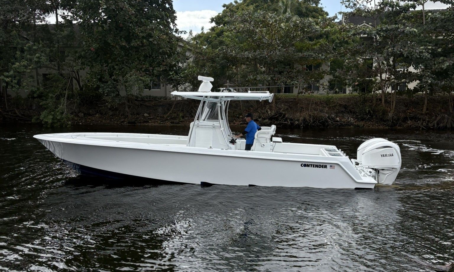 2025 Contender 32 ST boat on calm water.