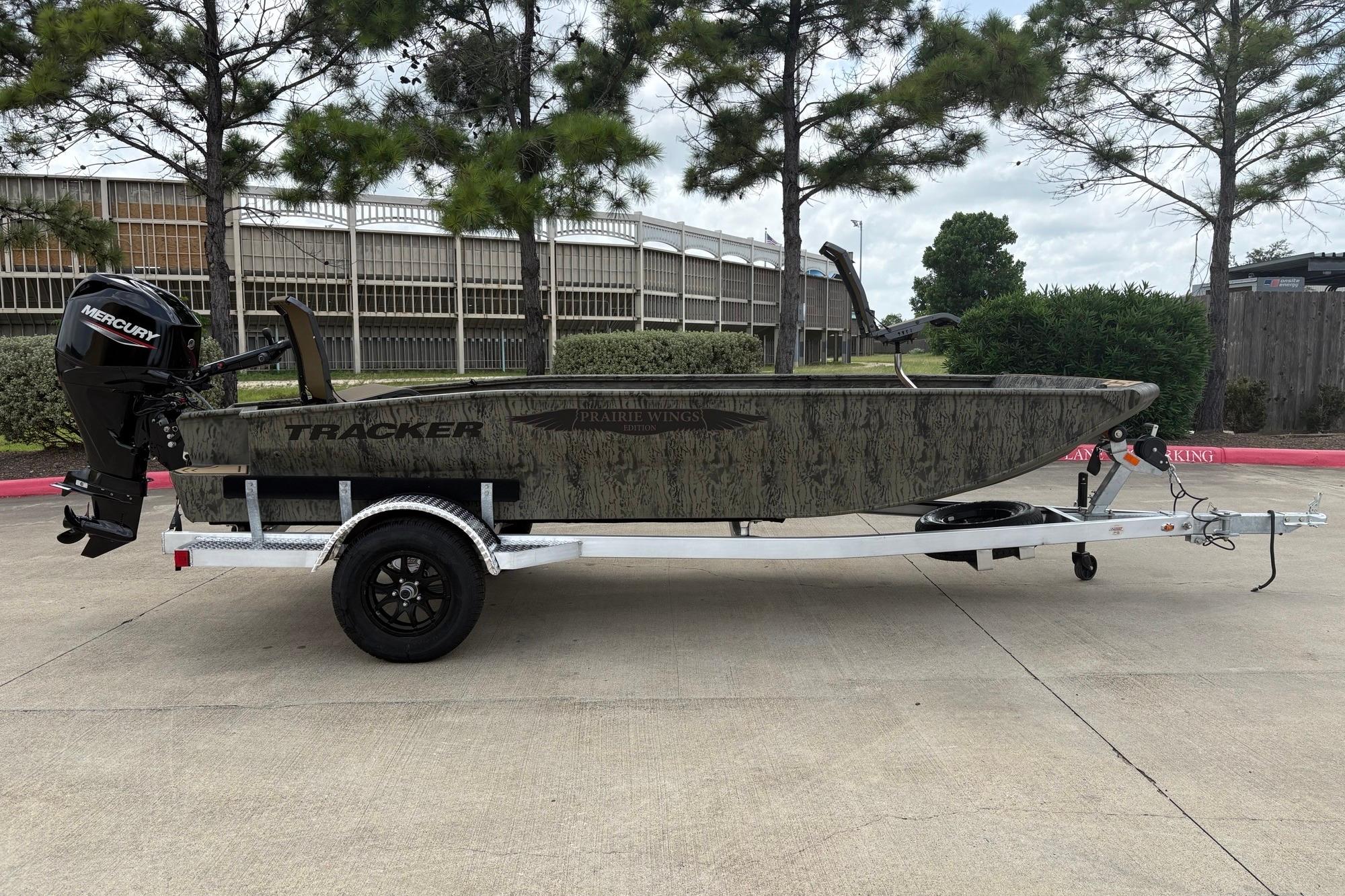 2026 Tracker Grizzly 1650 T Prairie Wings Edition boat on trailer, outdoors.