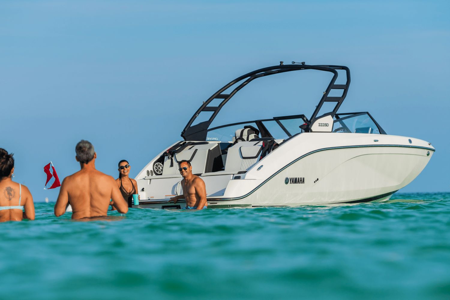 A 2026 Yamaha 222SD floats on clear water, surrounded by people swimming.