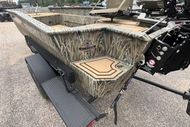 2026 Tracker Grizzly 1650 T Prairie Wings Edition boat with camouflage design on a trailer.