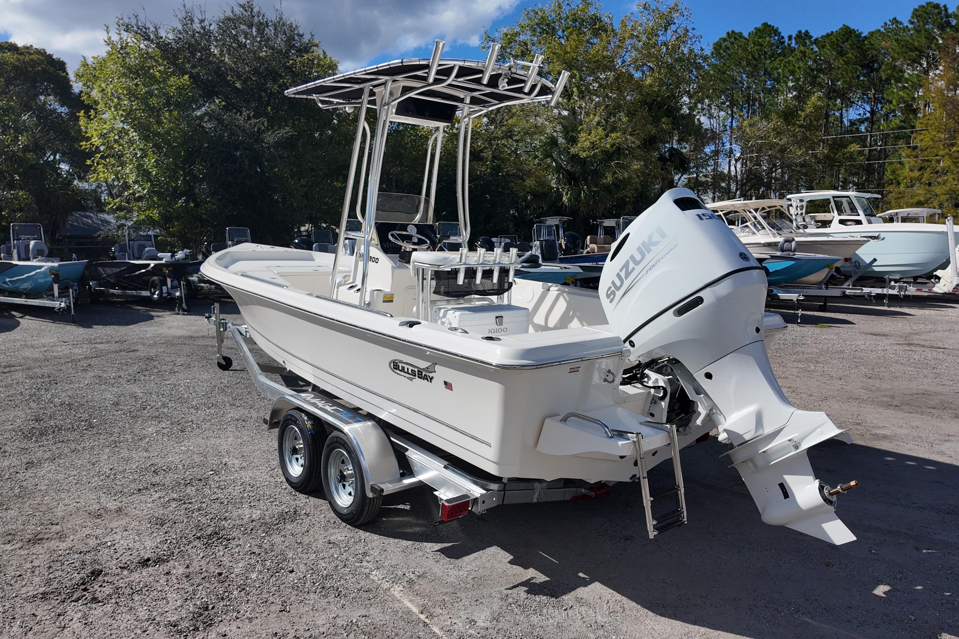 2026 Bulls Bay 2200 boat with Suzuki engine on a trailer in a sunny outdoor setting.
