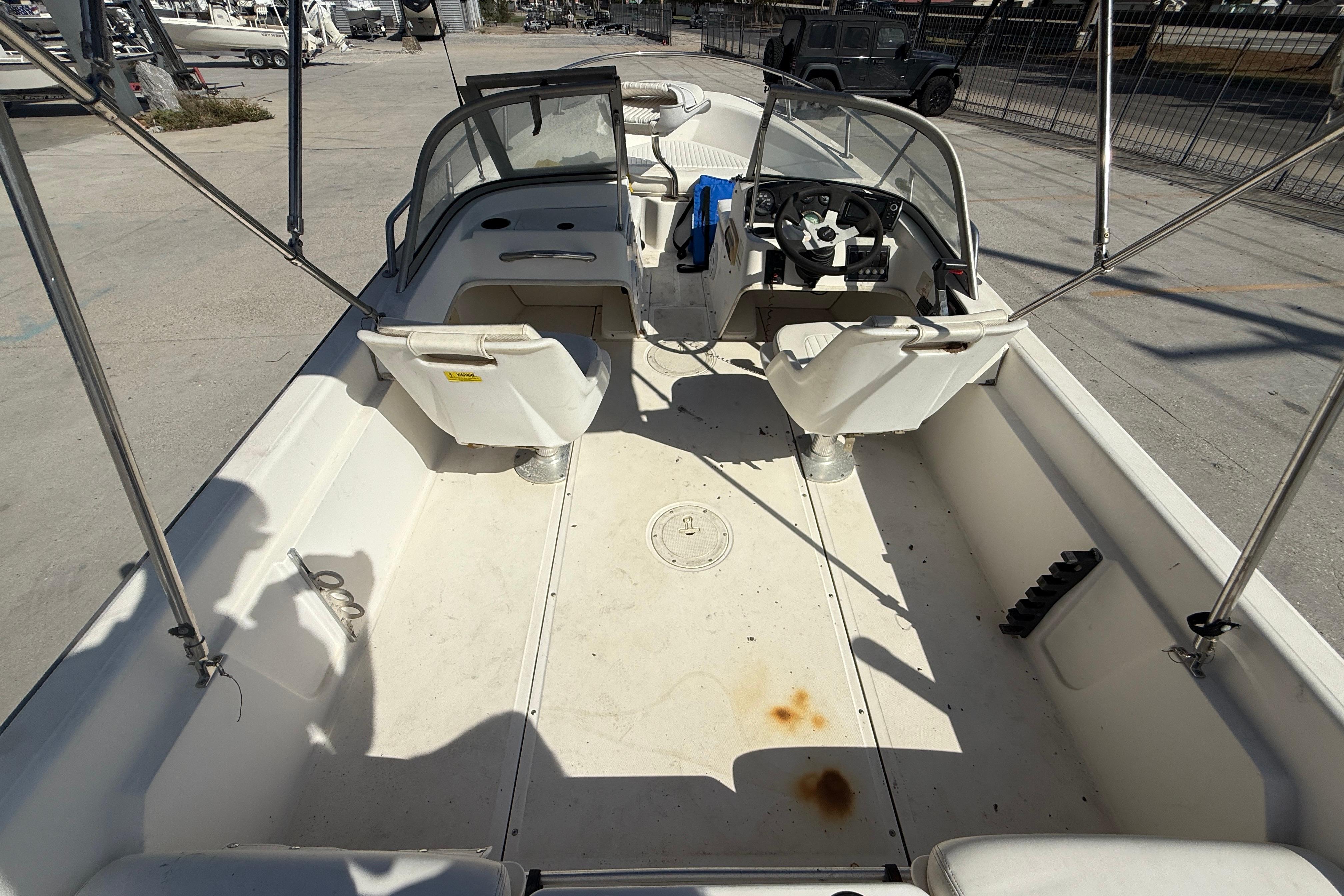2002 Boston Whaler Ventura 160 boat interior with seating and steering wheel.