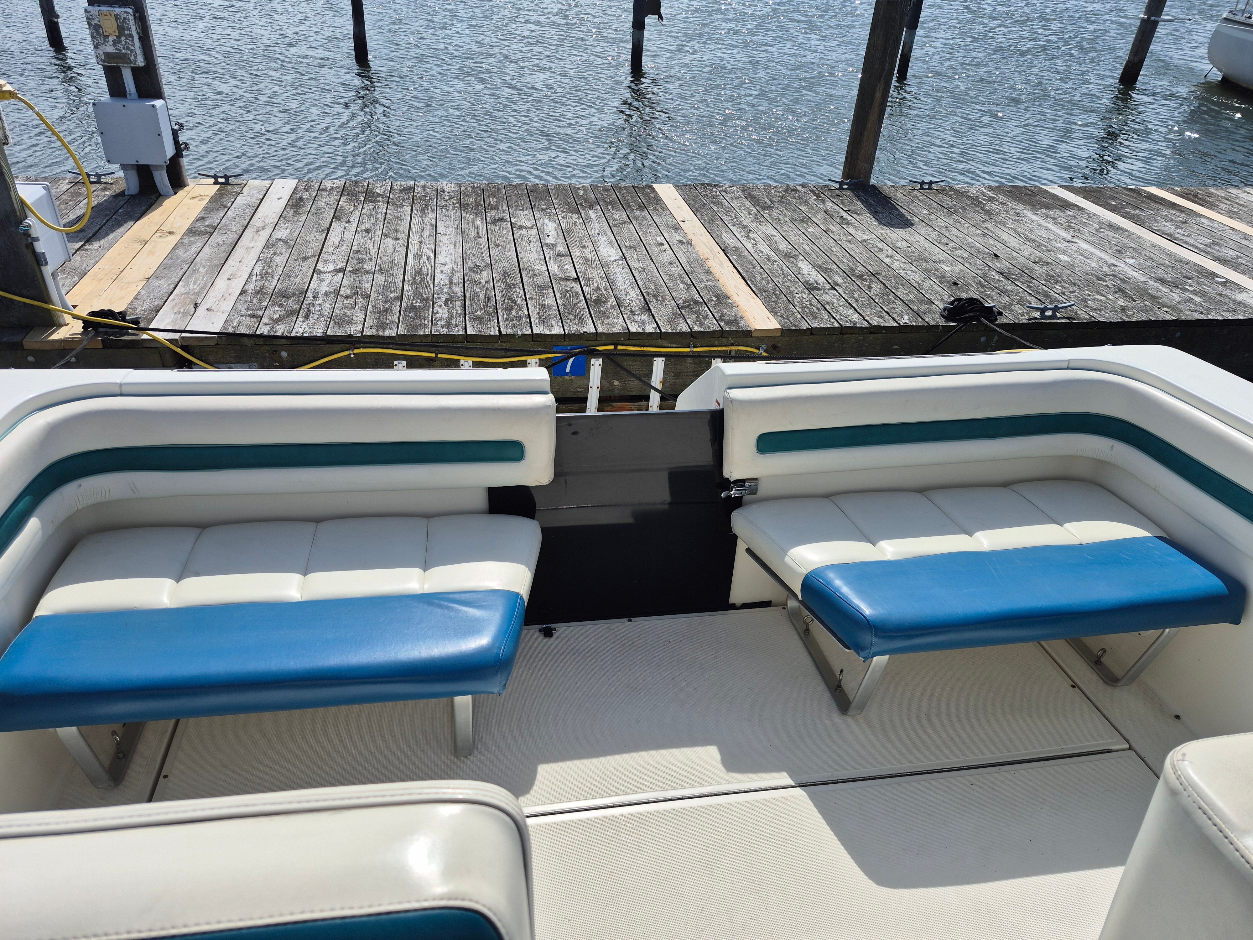 Interior view of a 1989 Tiara Yachts Slickcraft with blue and white seating at the dock.