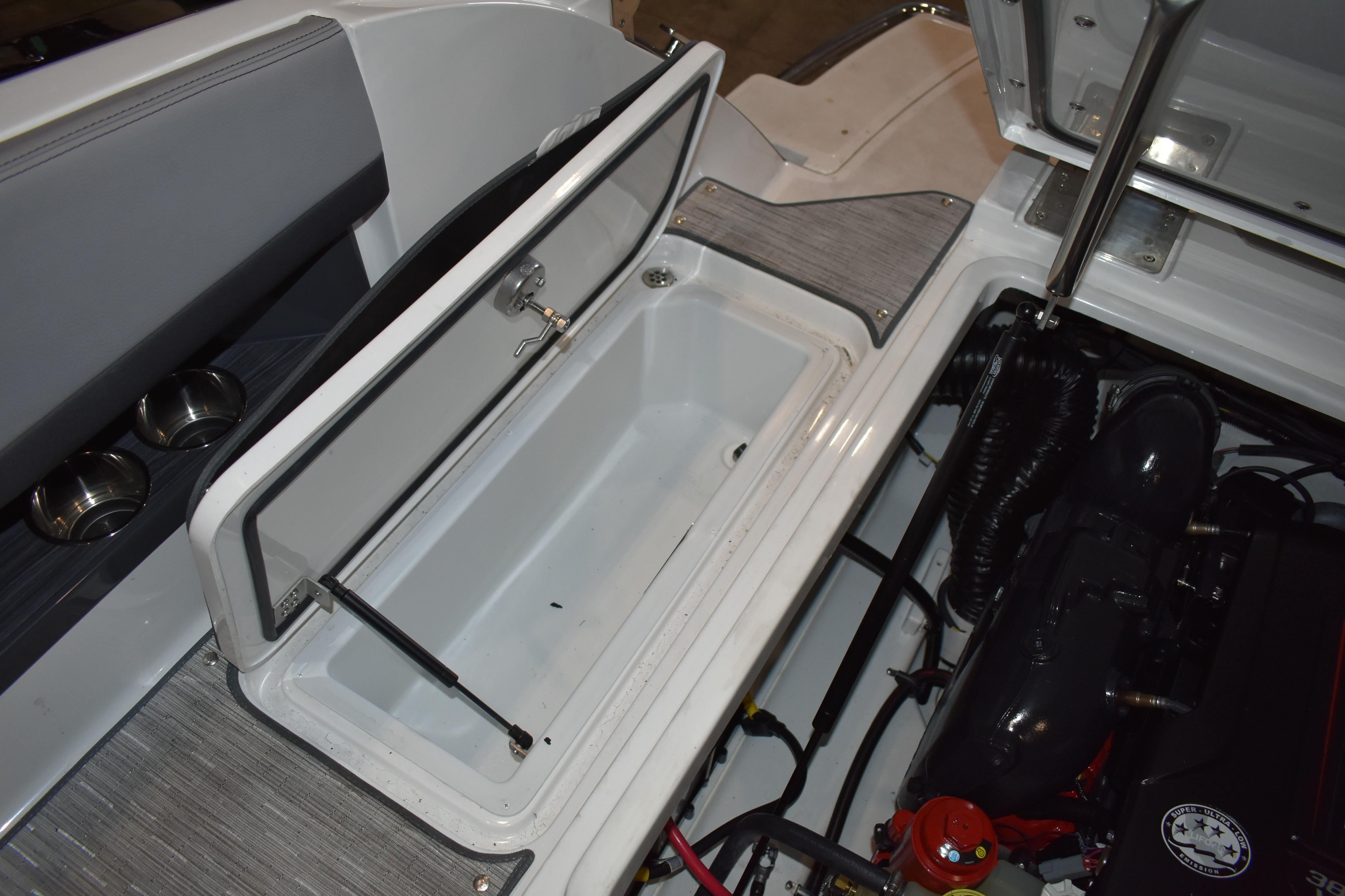 2023 Cobalt R8 boat engine compartment with open storage hatch and visible engine components.