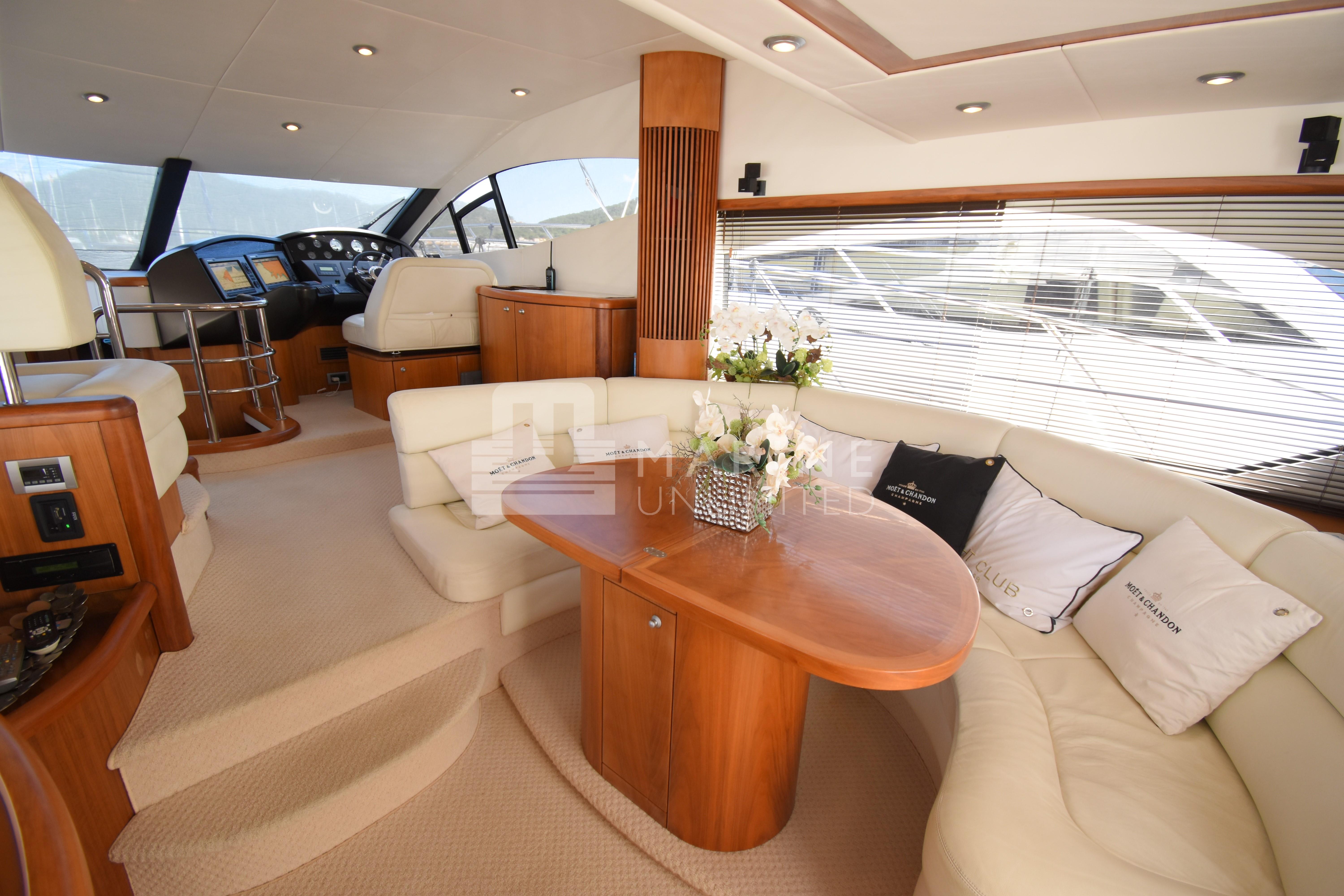 Luxurious interior of 2010 Sunseeker Manhattan 52 yacht with elegant seating and wooden accents.