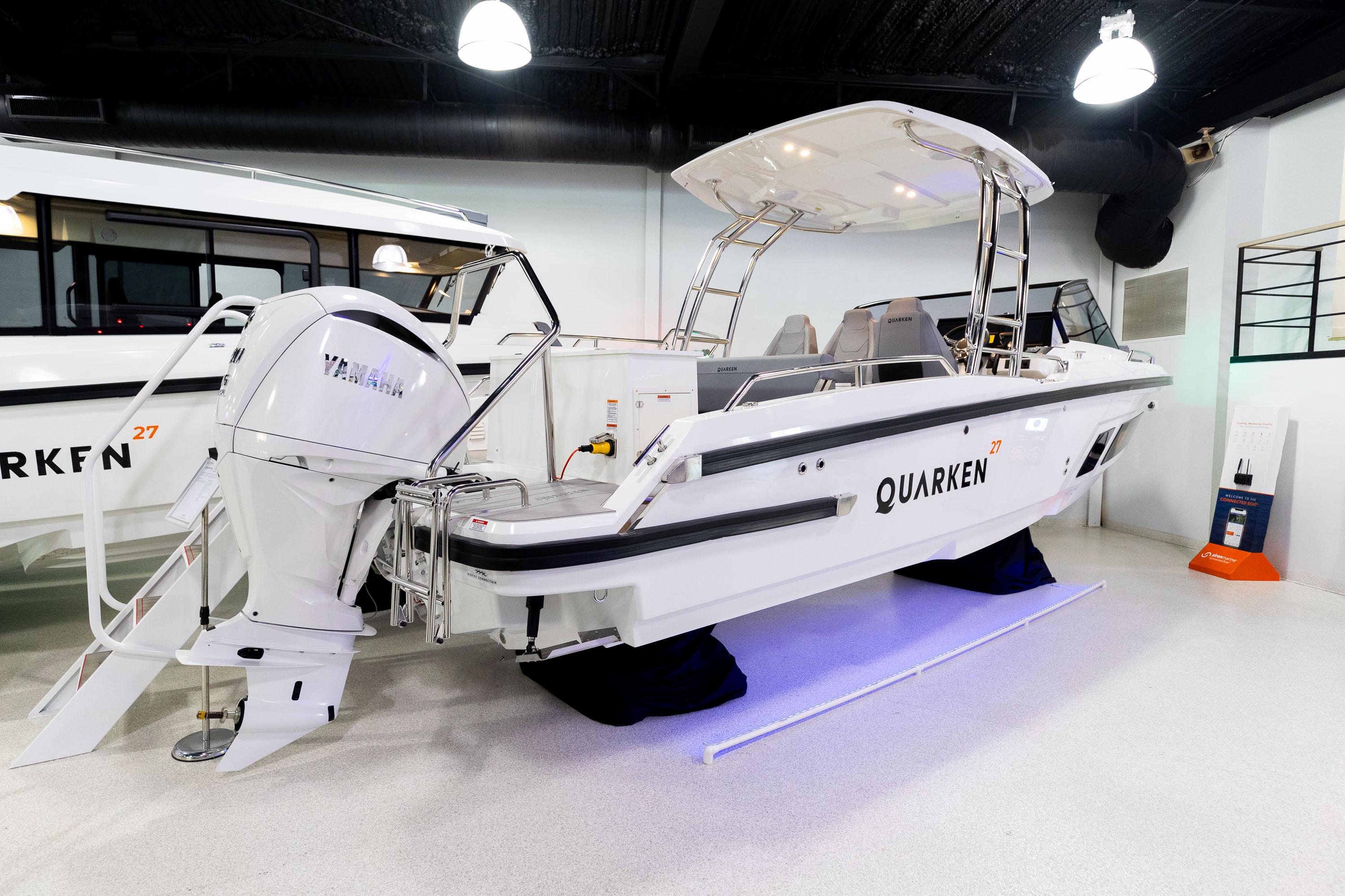 2024 Quarken 27 T-Top V2 boat with Yamaha engine in showroom setting.