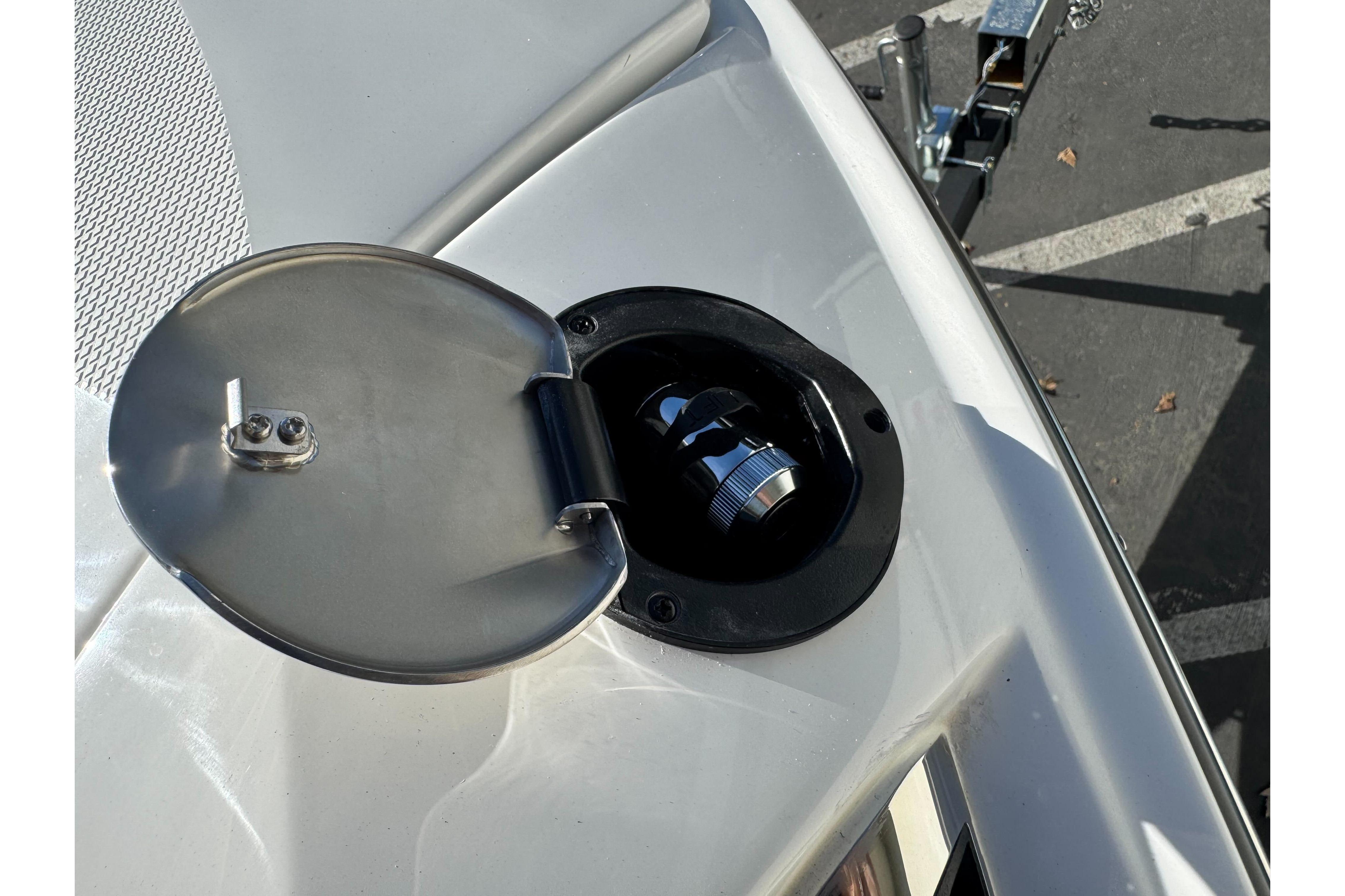 Fuel cap on 2026 Sea Ray SLX 260 boat, open with metal cover.