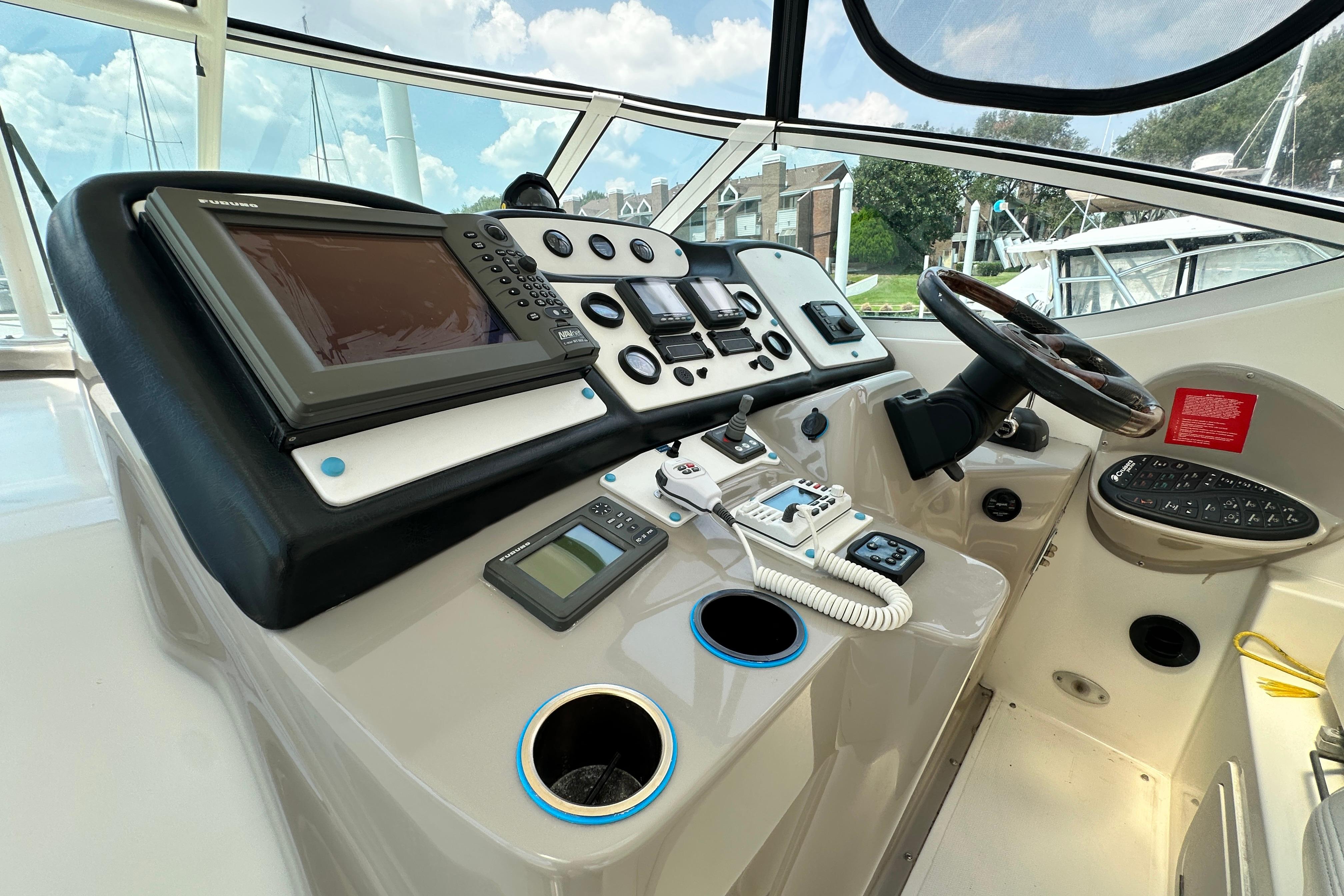 2004 Cruisers Yachts 405 Express Motoryacht helm with navigation equipment and steering wheel.