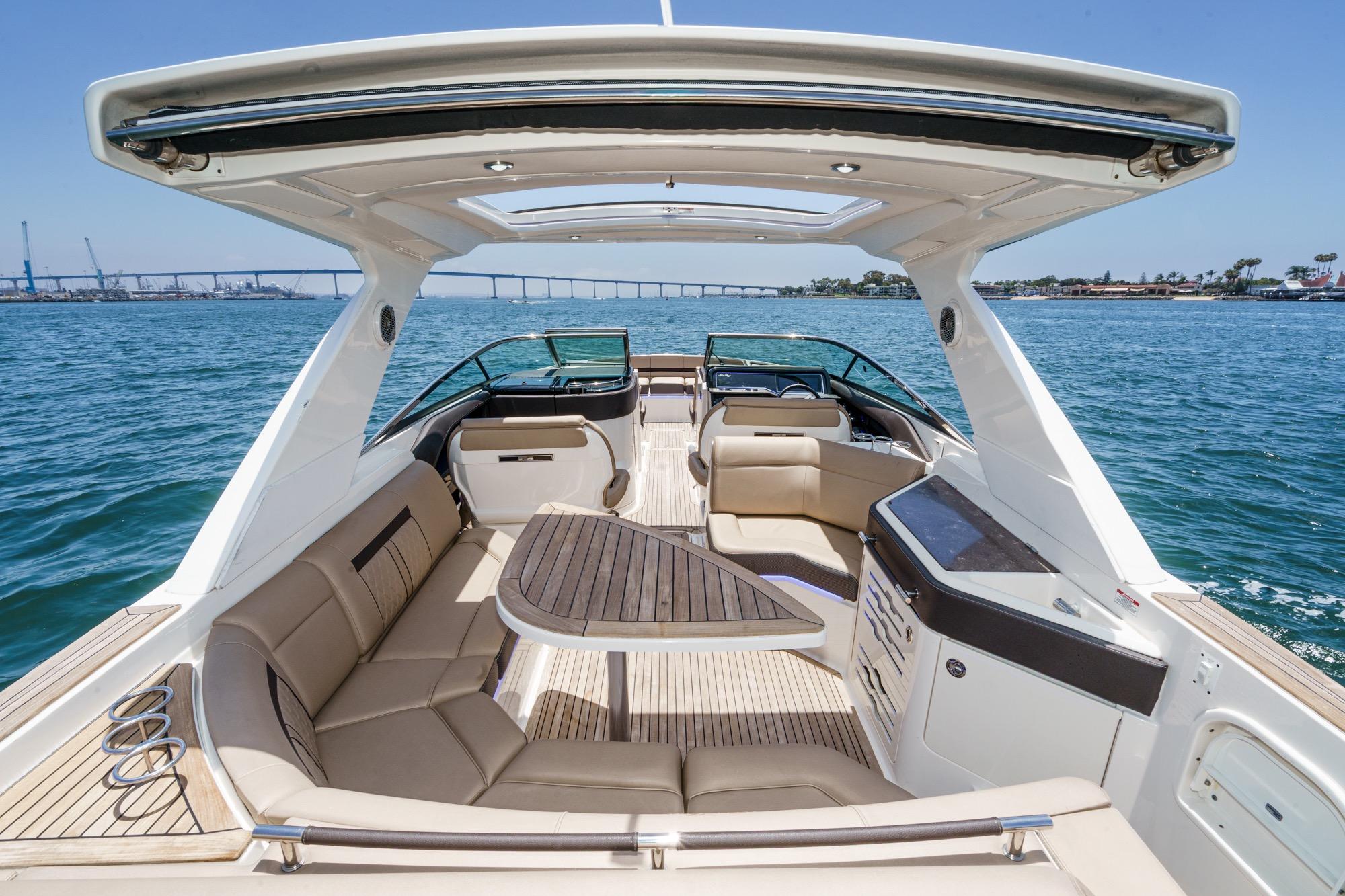 2018 Sea Ray SLX 310 luxury boat interior with spacious seating and elegant design on open water.