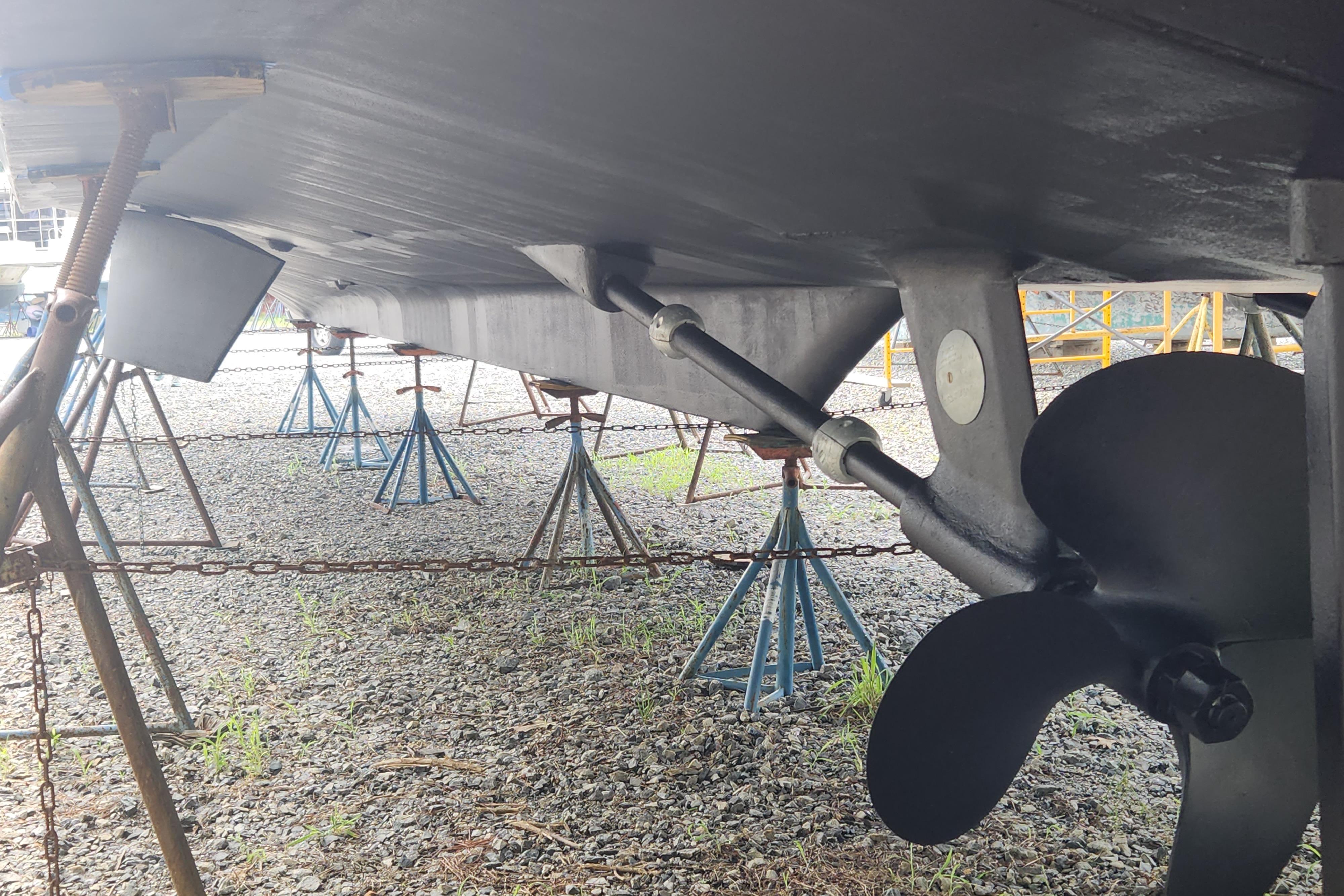 Underneath view of a 2004 Grand Harbour 58 yacht on stands, showing propeller and hull.