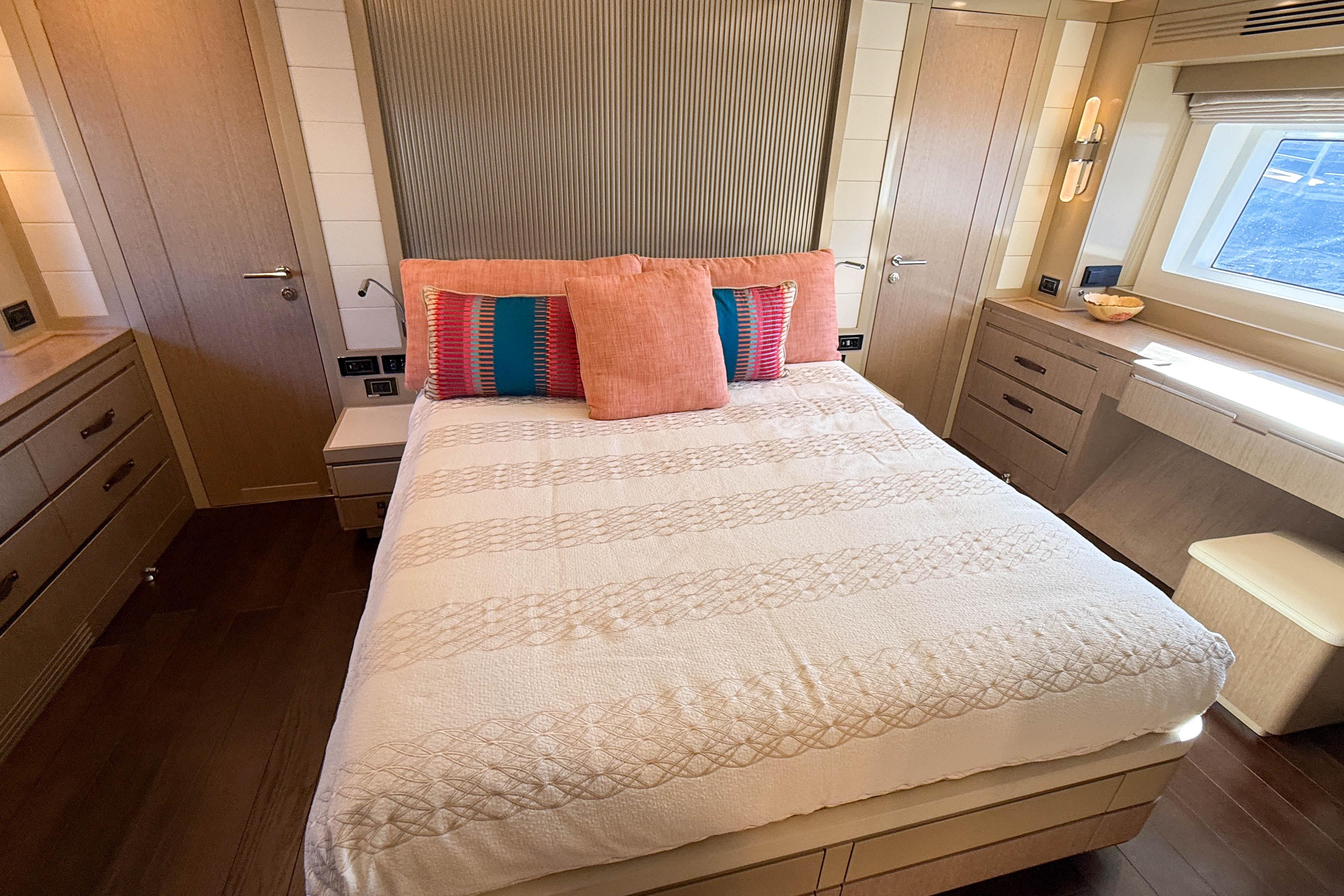 Luxurious bedroom interior of 2023 Sirena 68 yacht with elegant decor and natural light.