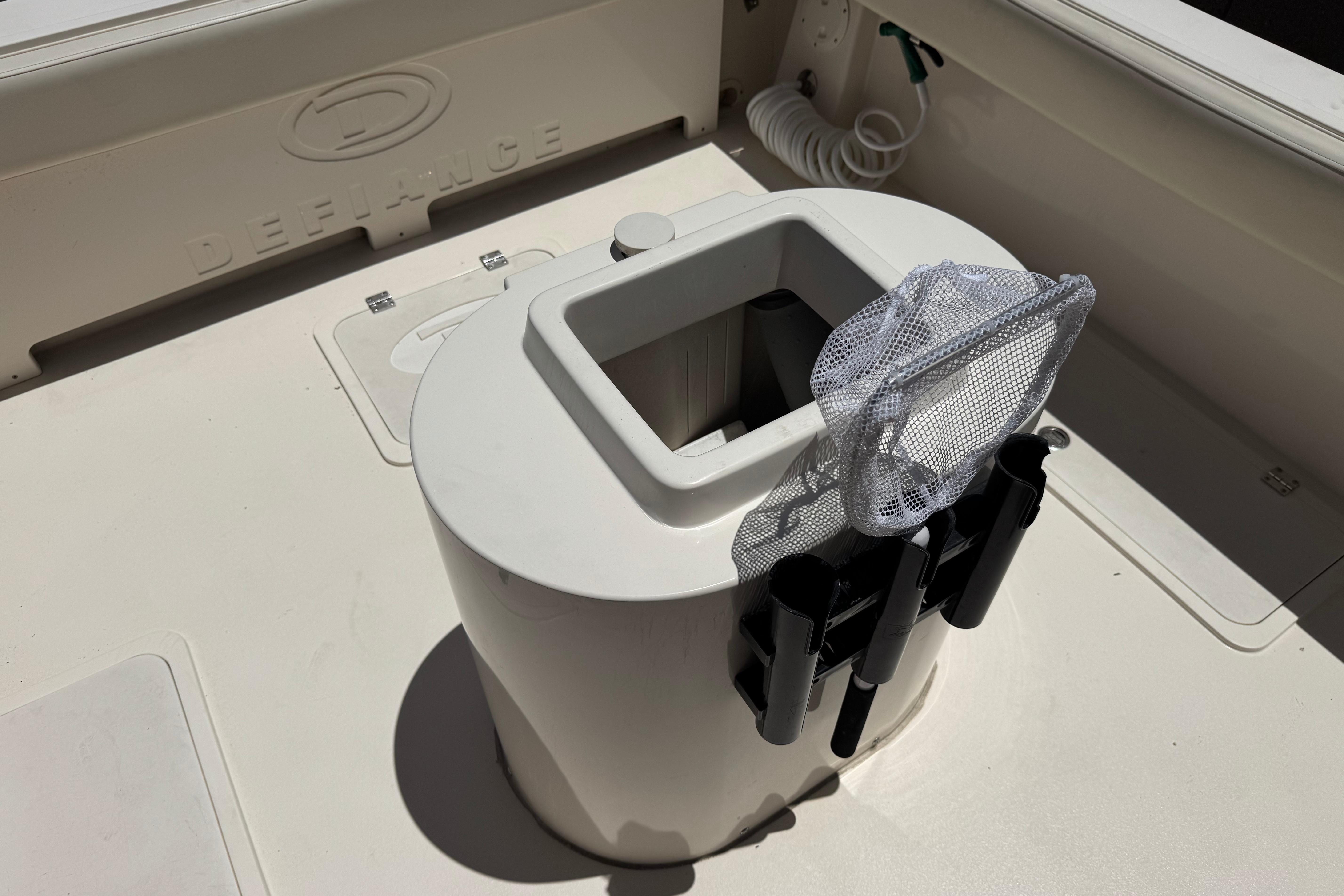2017 Defiance Admiral 220 EX boat deck with storage compartment and fishing rod holders.