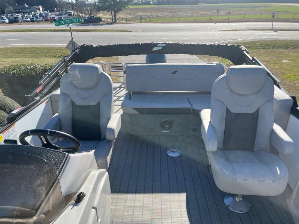 2024 Starcraft SLS3 boat interior with white seating and steering wheel.