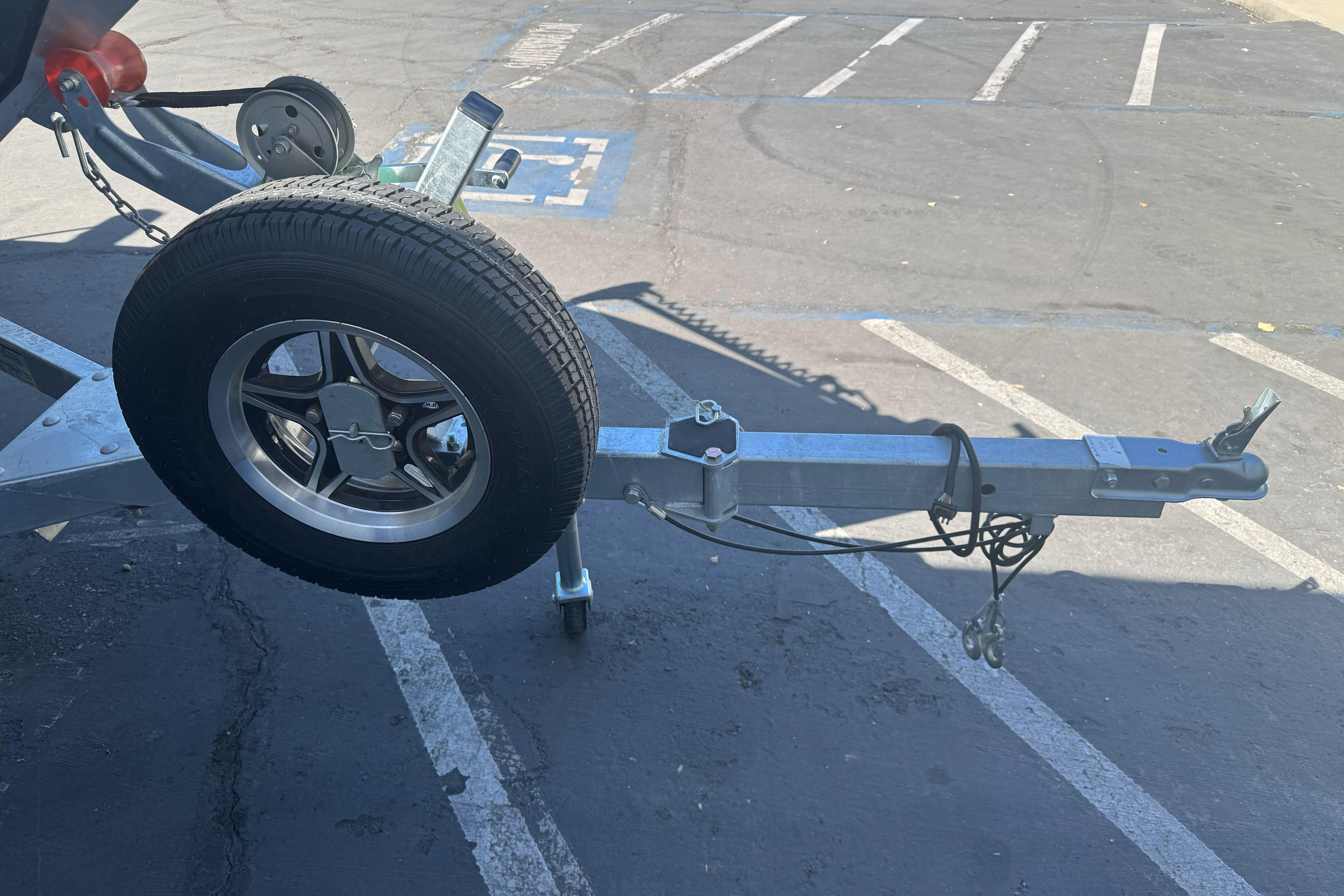 Trailer hitch with spare tire on a 2026 KingFisher 16 Falcon boat trailer.