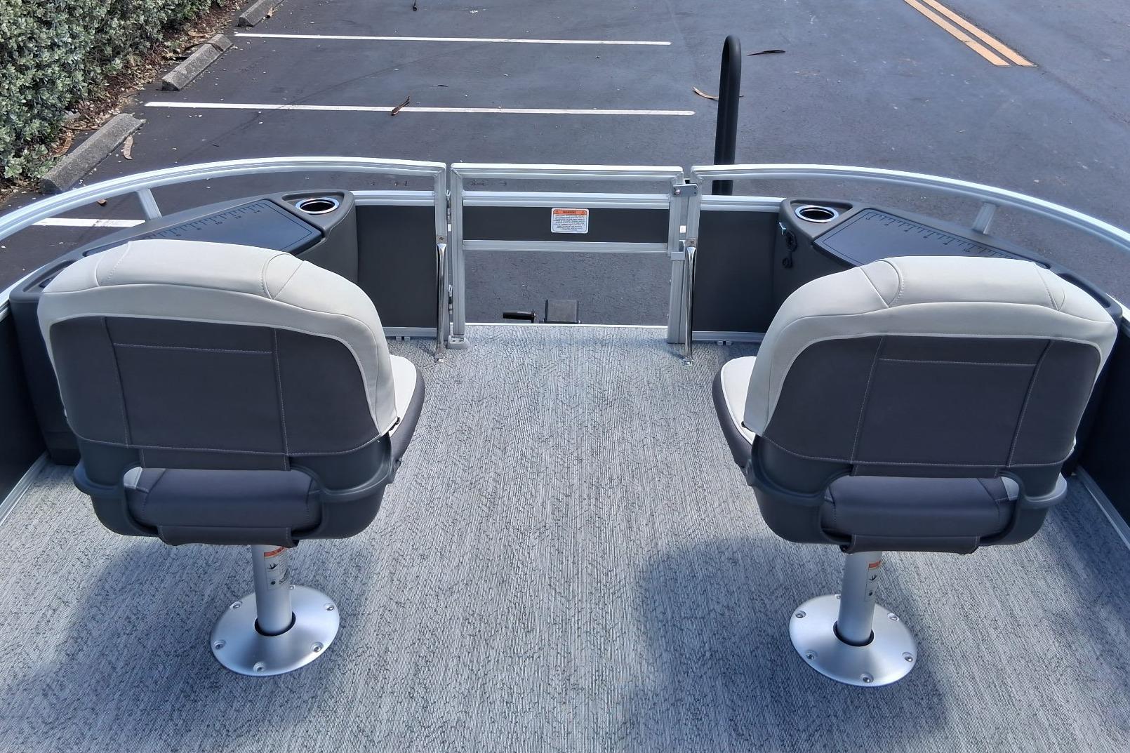 2026 Sun Tracker Bass Buggy 18 DLX pontoon boat with two swivel seats.