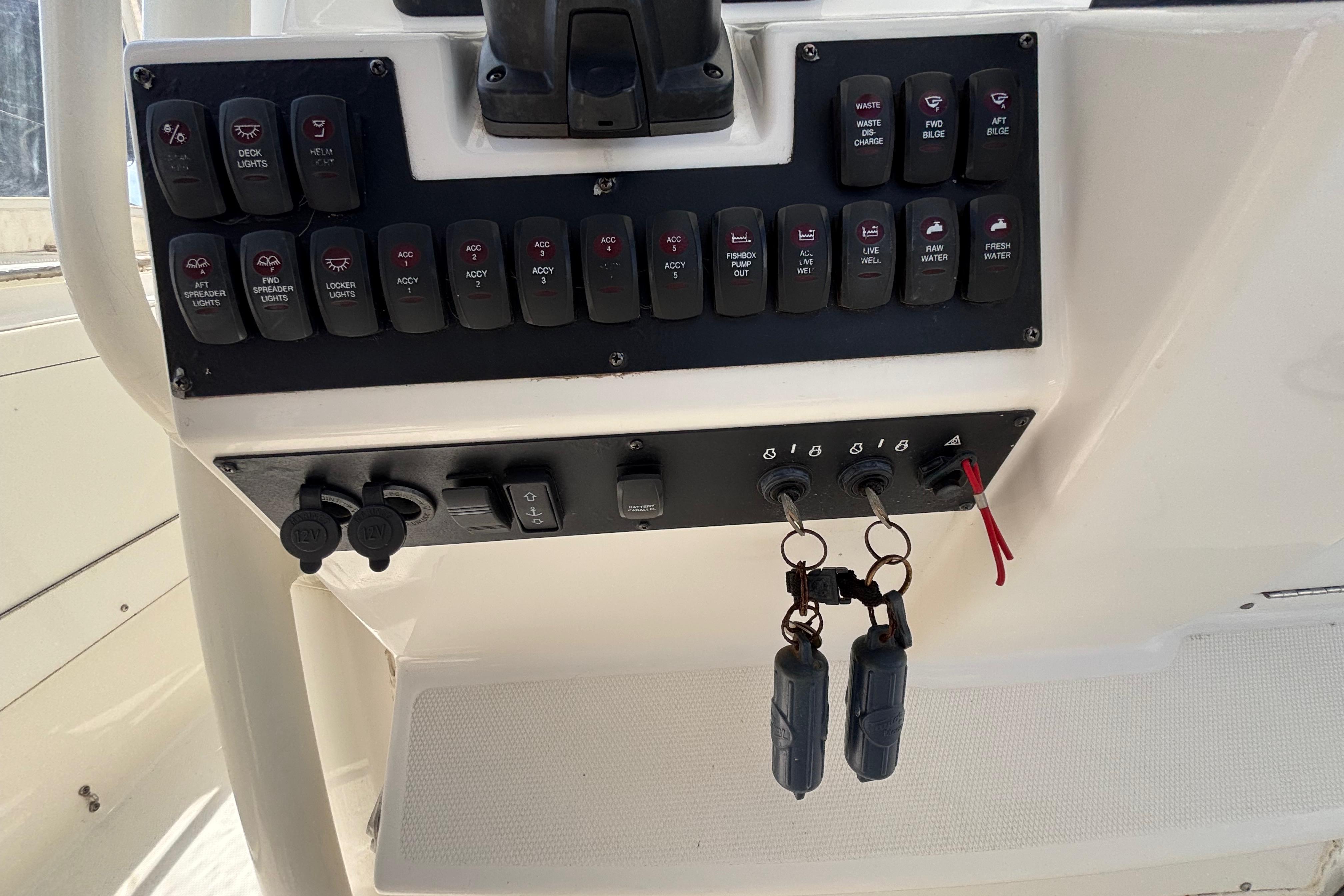 Control panel of a 2006 Edgewater 318CC boat with switches and keys.