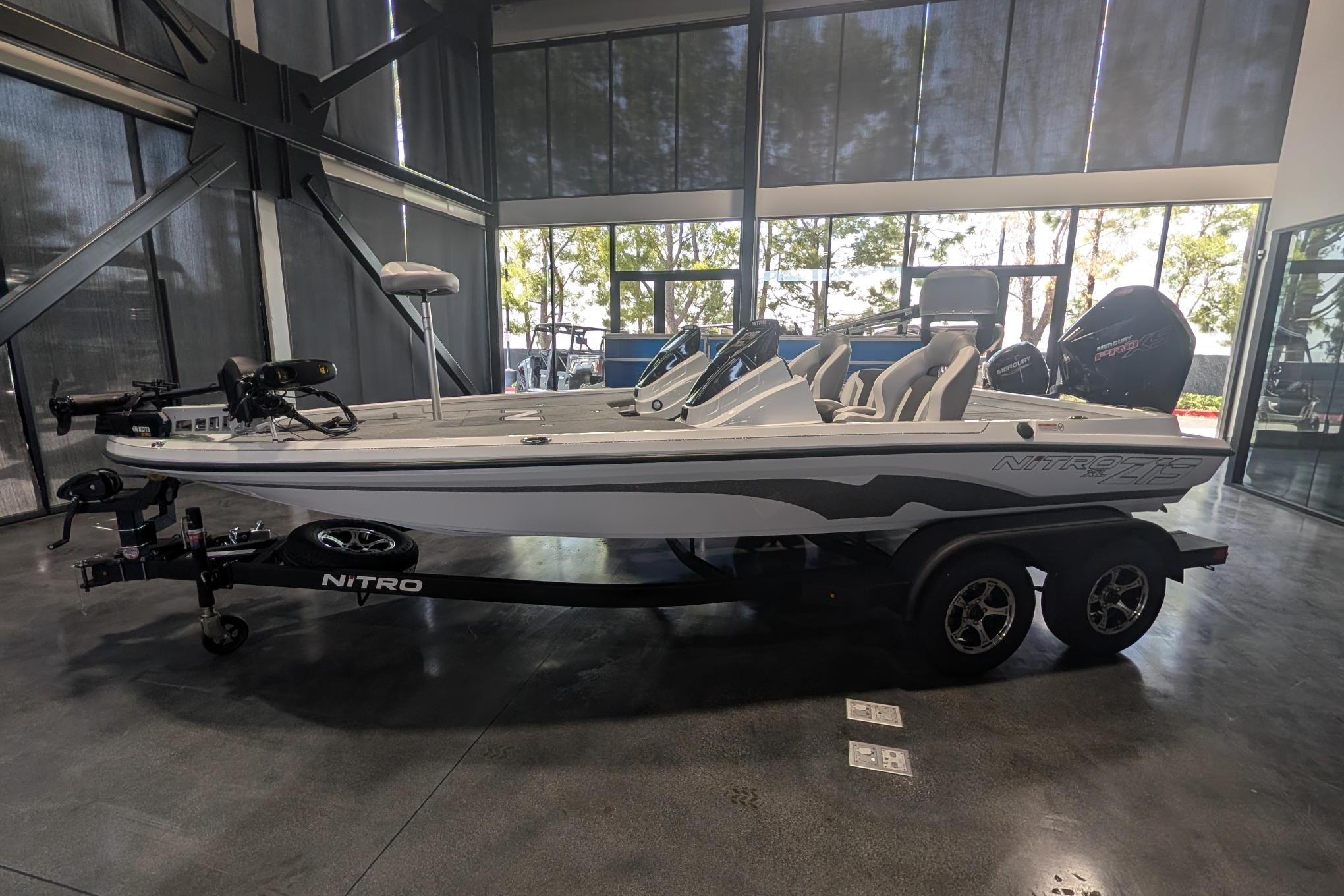 2026 Nitro Z19 XL Pro boat in showroom, sleek design, dual axle trailer.
