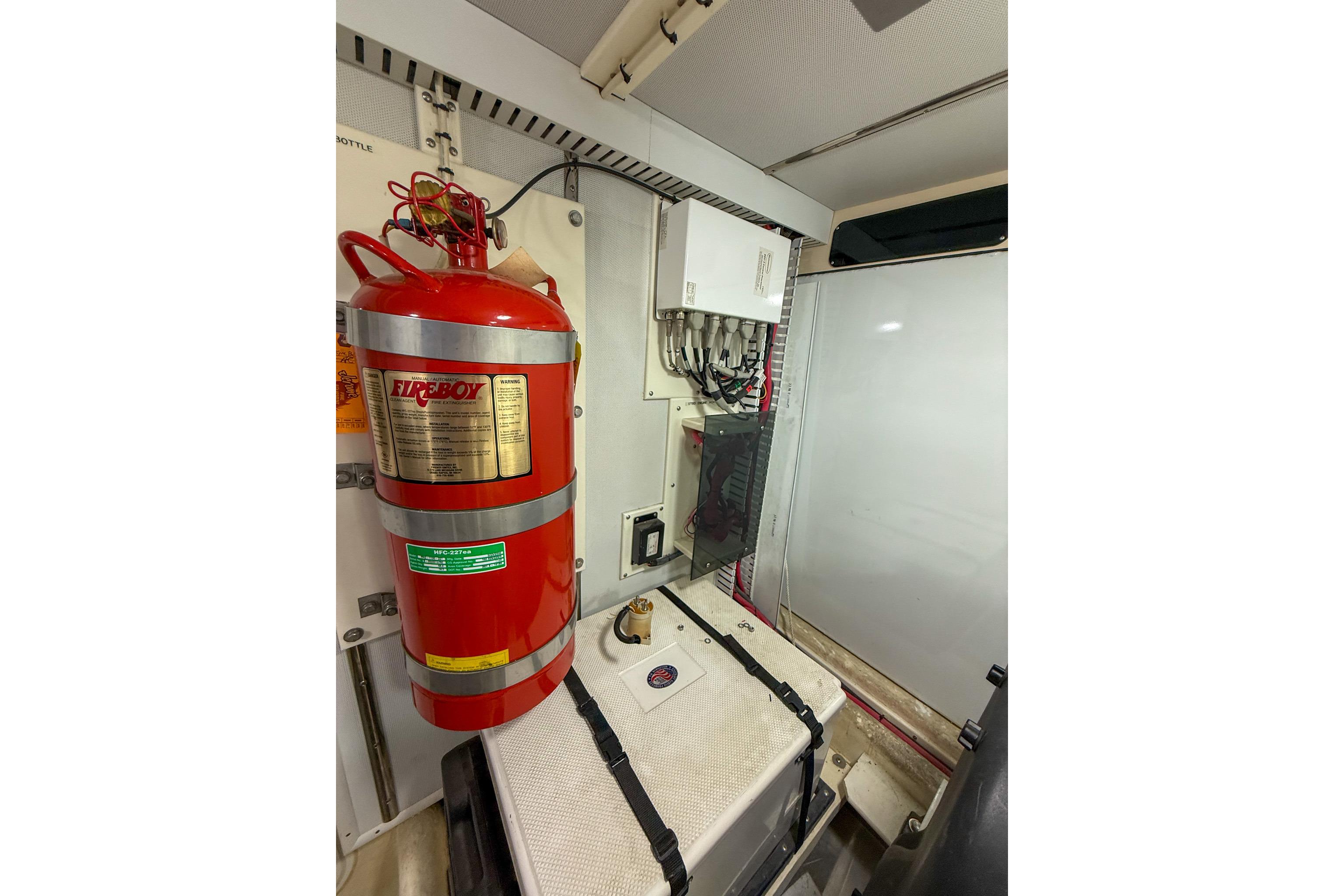 Engine room of 2007 Nordic Tug 54 with fire extinguisher and electrical panel.