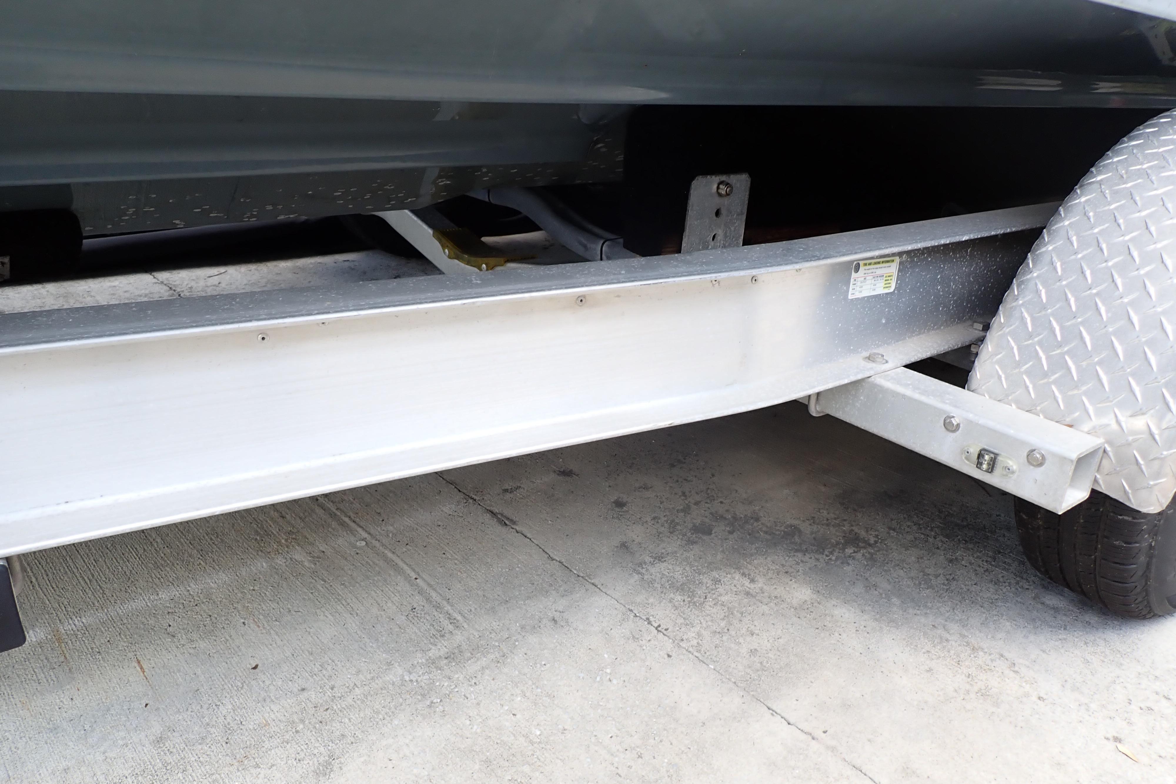 Trailer detail of a 2019 Key West 263 FS boat, showing wheel and frame.