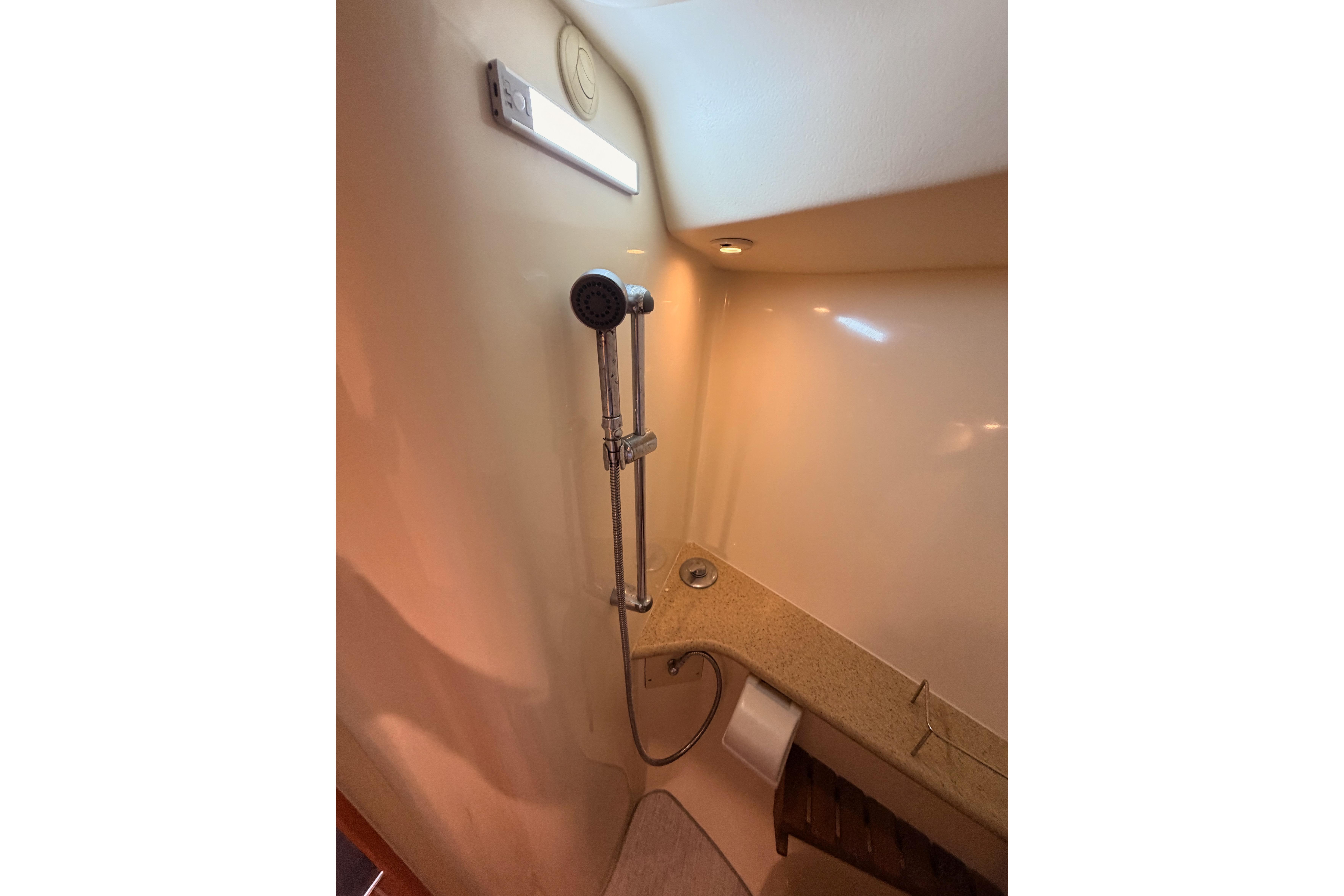 Shower area in 2008 Hunter 45 Deck Salon yacht, featuring modern fixtures and lighting.
