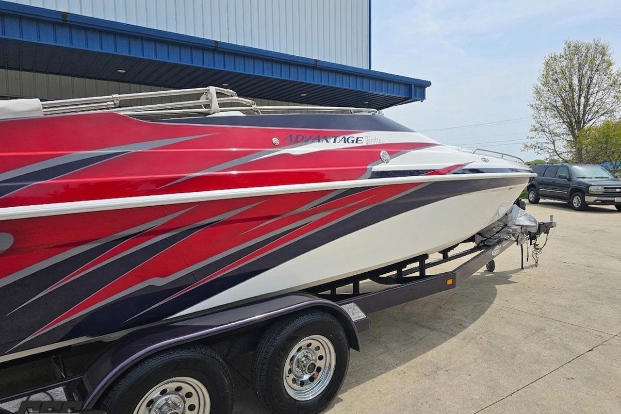 2019 Advantage 25 Citation Bowrider boat with vibrant red and white design on trailer.